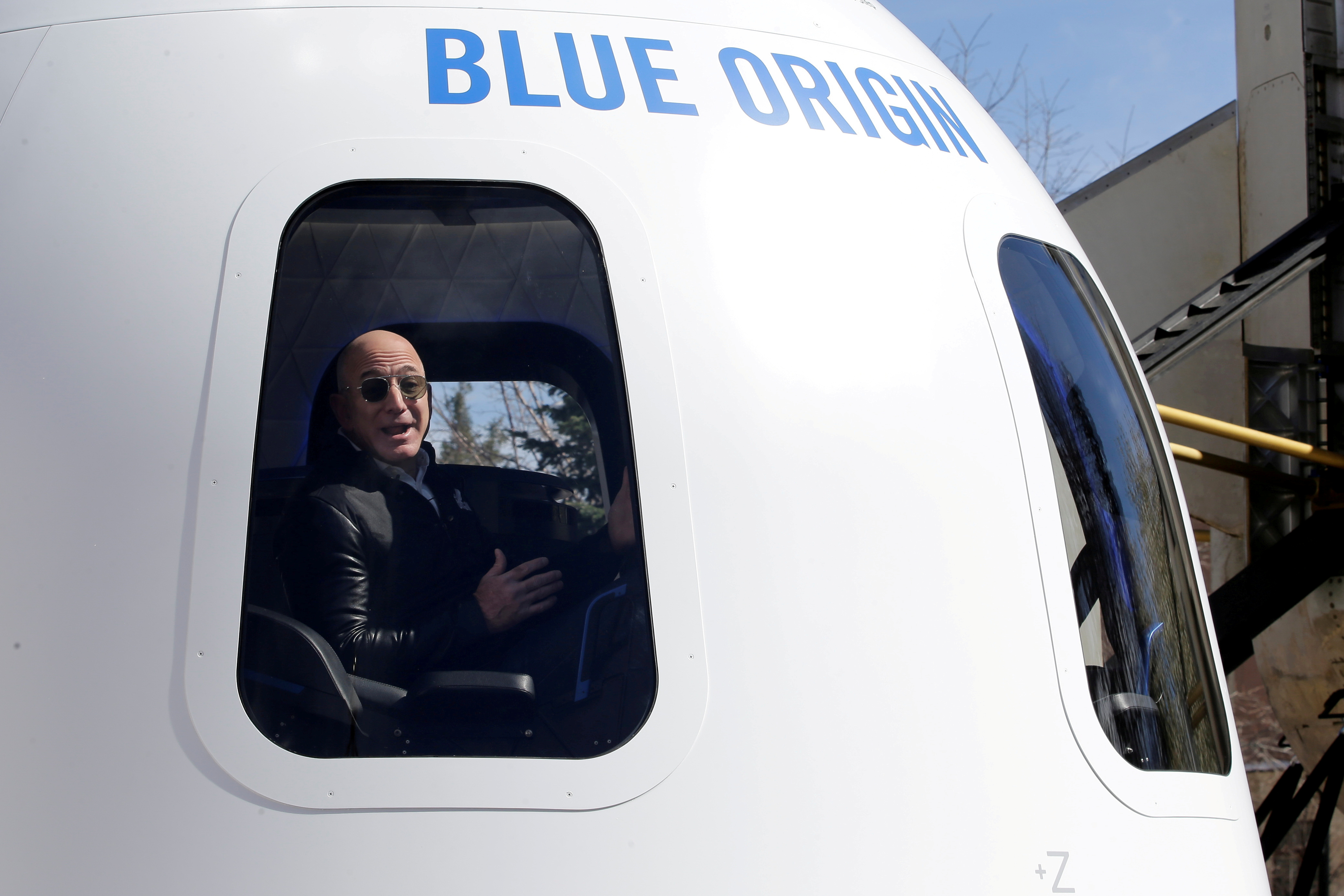 Amazon and Blue Origin founder Jeff Bezos addresses the media about the New Shepard rocket booster and Crew Capsule mockup at the 33rd Space Symposium in Colorado Springs