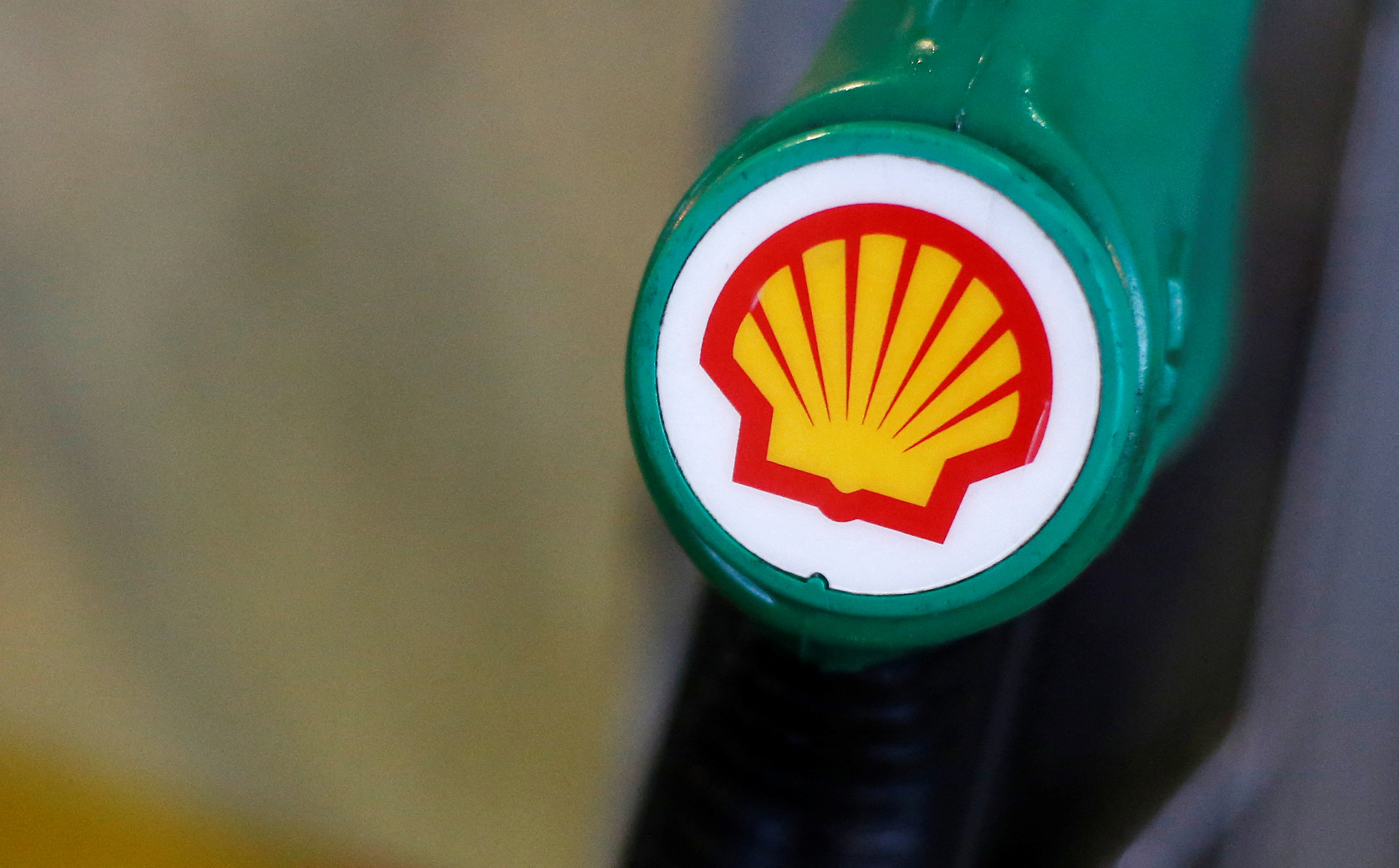 The Shell logo is seen on a pump at a Shell petrol station in London