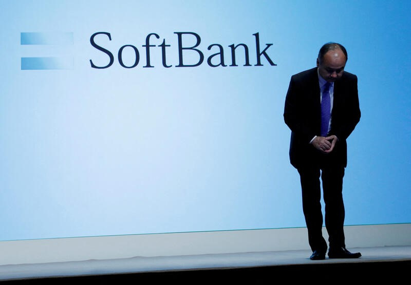 Japan's SoftBank Group Corp Chief Executive Masayoshi Son bows his head after his presentation at a news conference in Tokyo