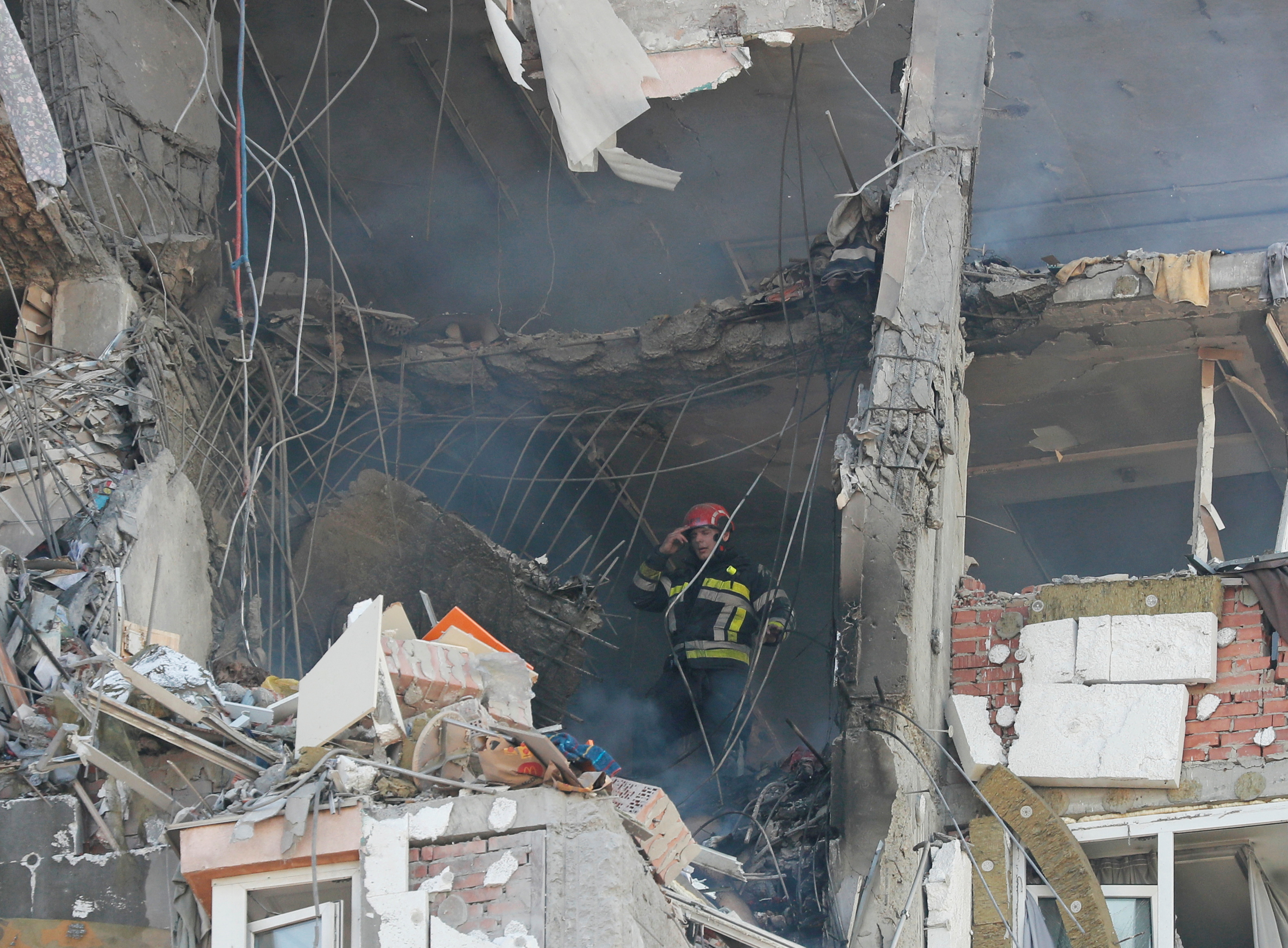 A firefighter works inside an apartment building damaged by recent shelling in Kyiv, Ukraine February 26, 2022. REUTERS/Gleb Garanich