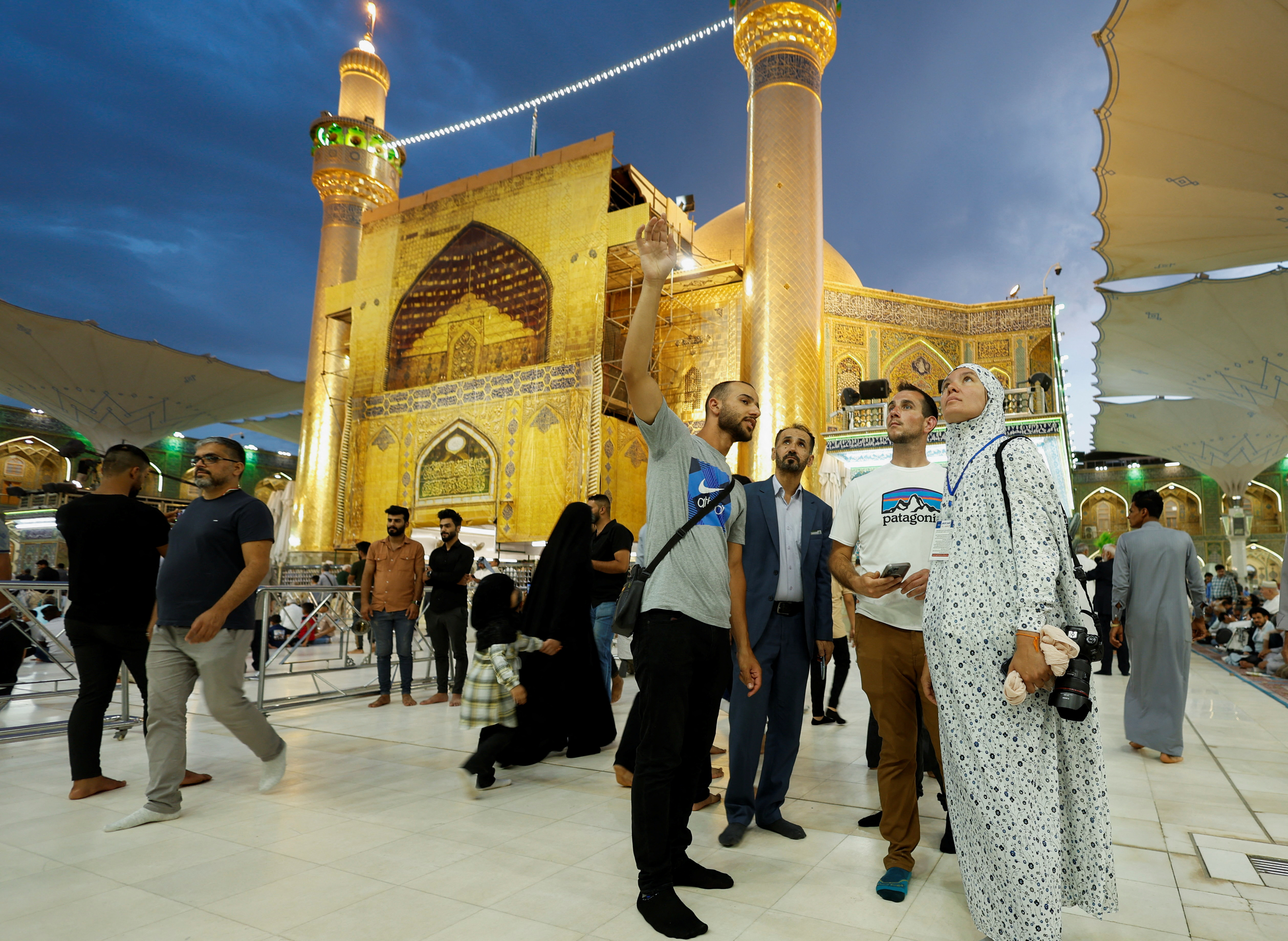 Anna Nikolaevna, 38, a Russian national, and Jacob Nemec, 29, an American national, during a tour at Imam Ali shrine, in the holy city of Najaf