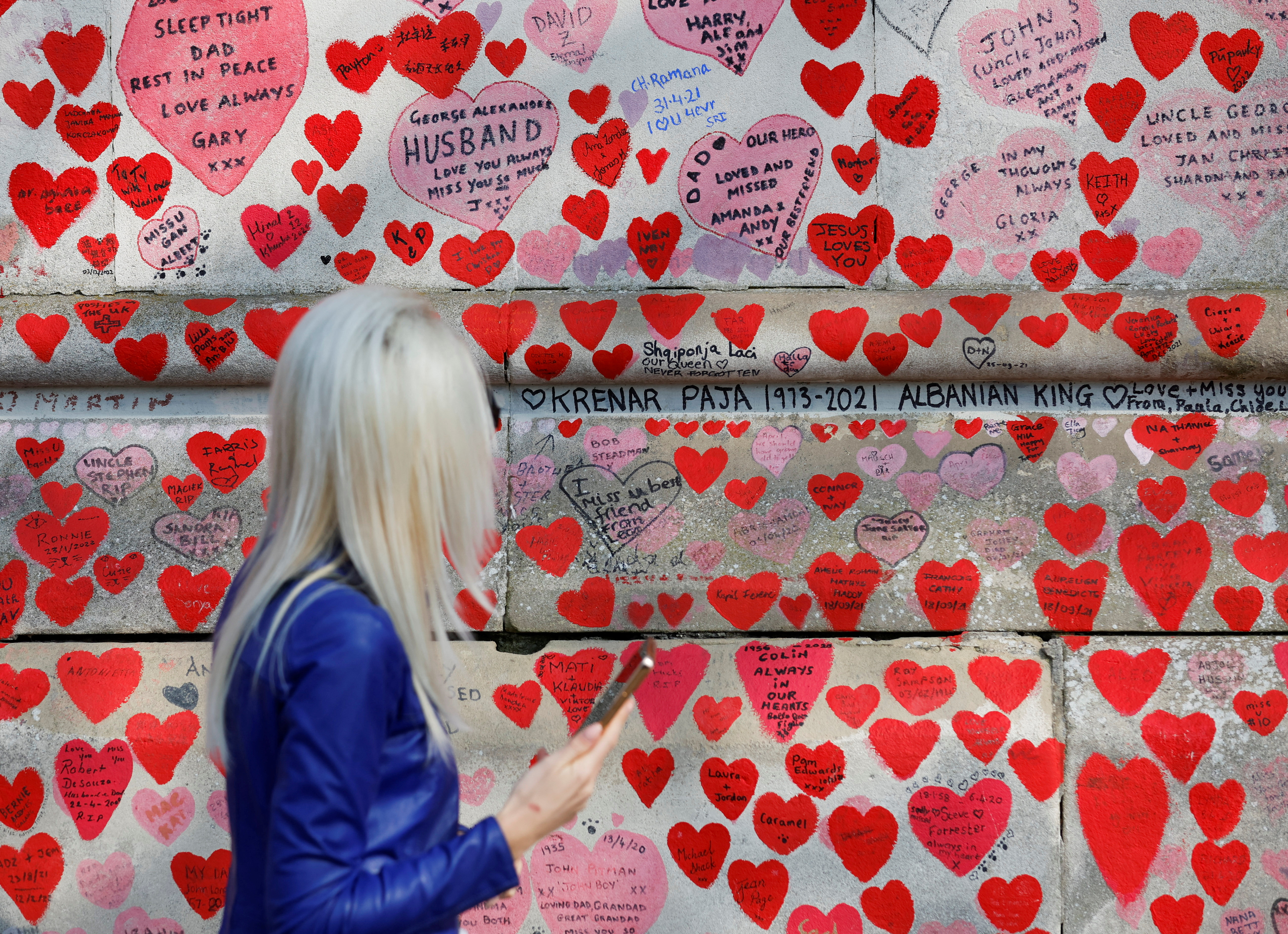 A person looks at The National Covid Memorial Wall, on national day of reflection to mark the two year anniversary of the UK going into national lockdown, in London