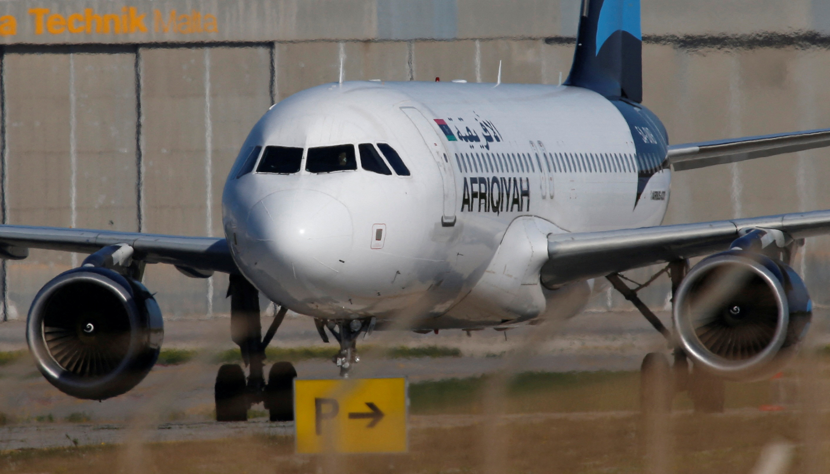 A hijacked Libyan Afriqiyah Airways Airbus A320 stands on the runway at Malta Airport
