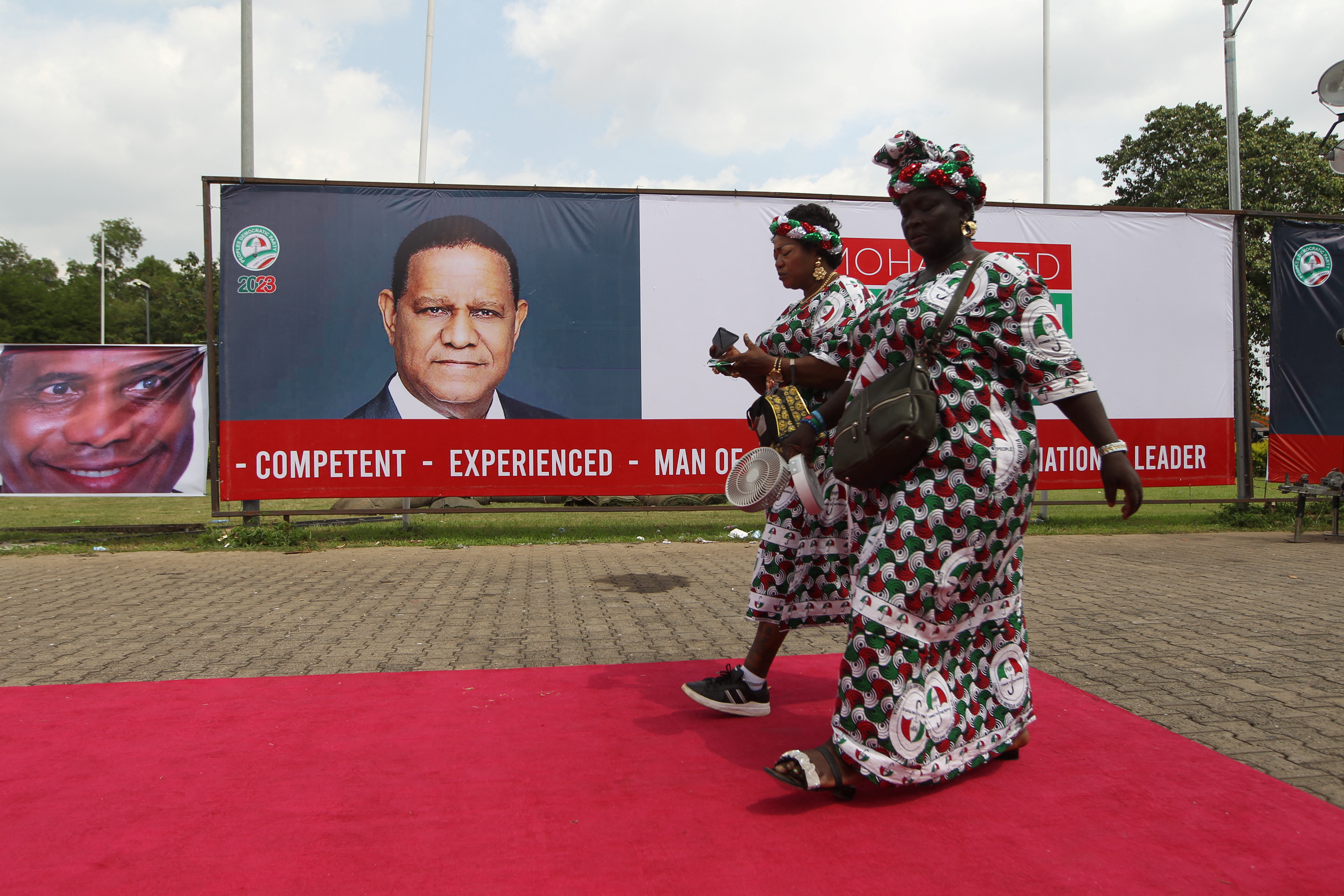 Two members of the People's Democratic Party arrive at the National convention centre in Abuja