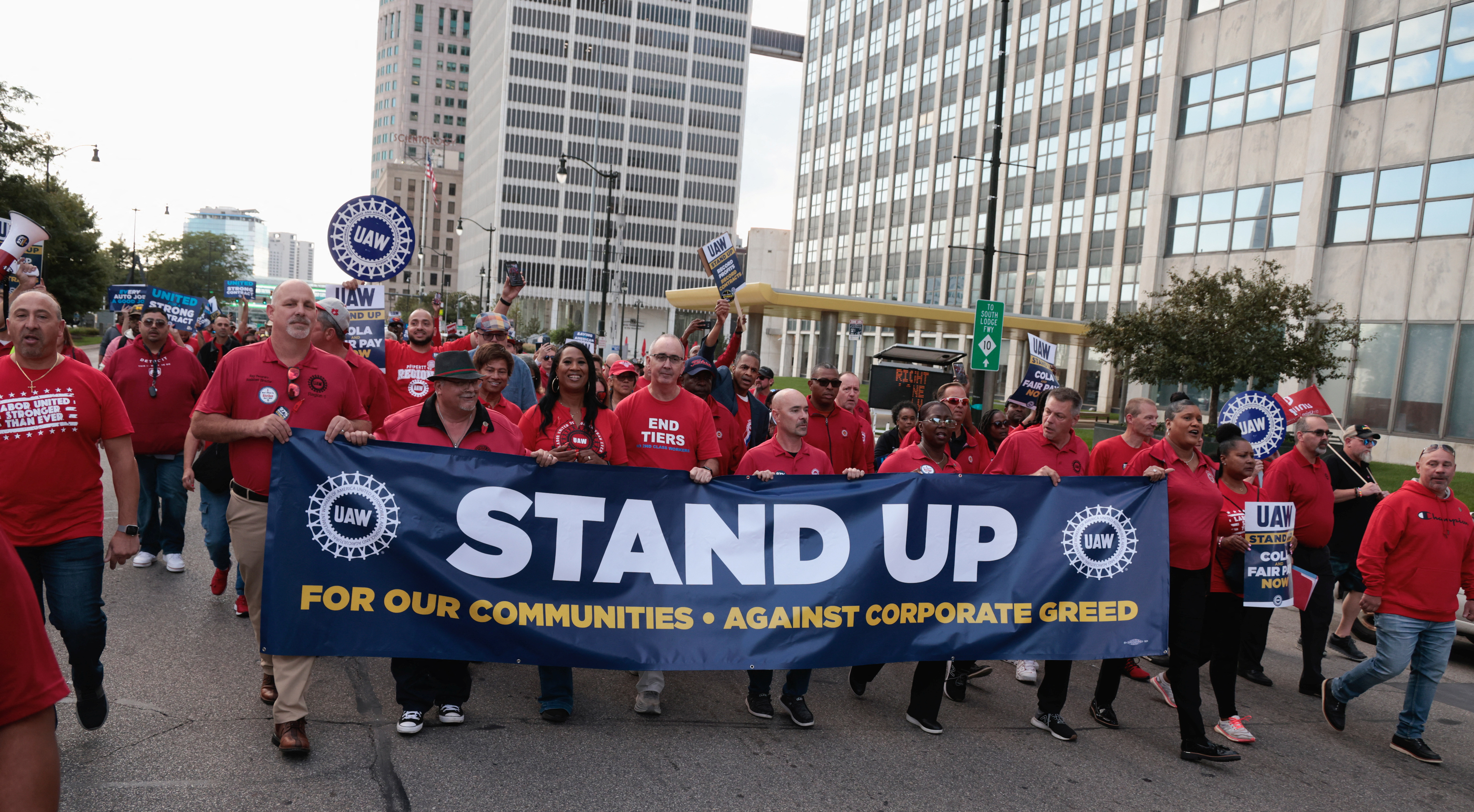 United Auto Workers president Shawn Fain and UAW members march in the street in support of striking UAW members