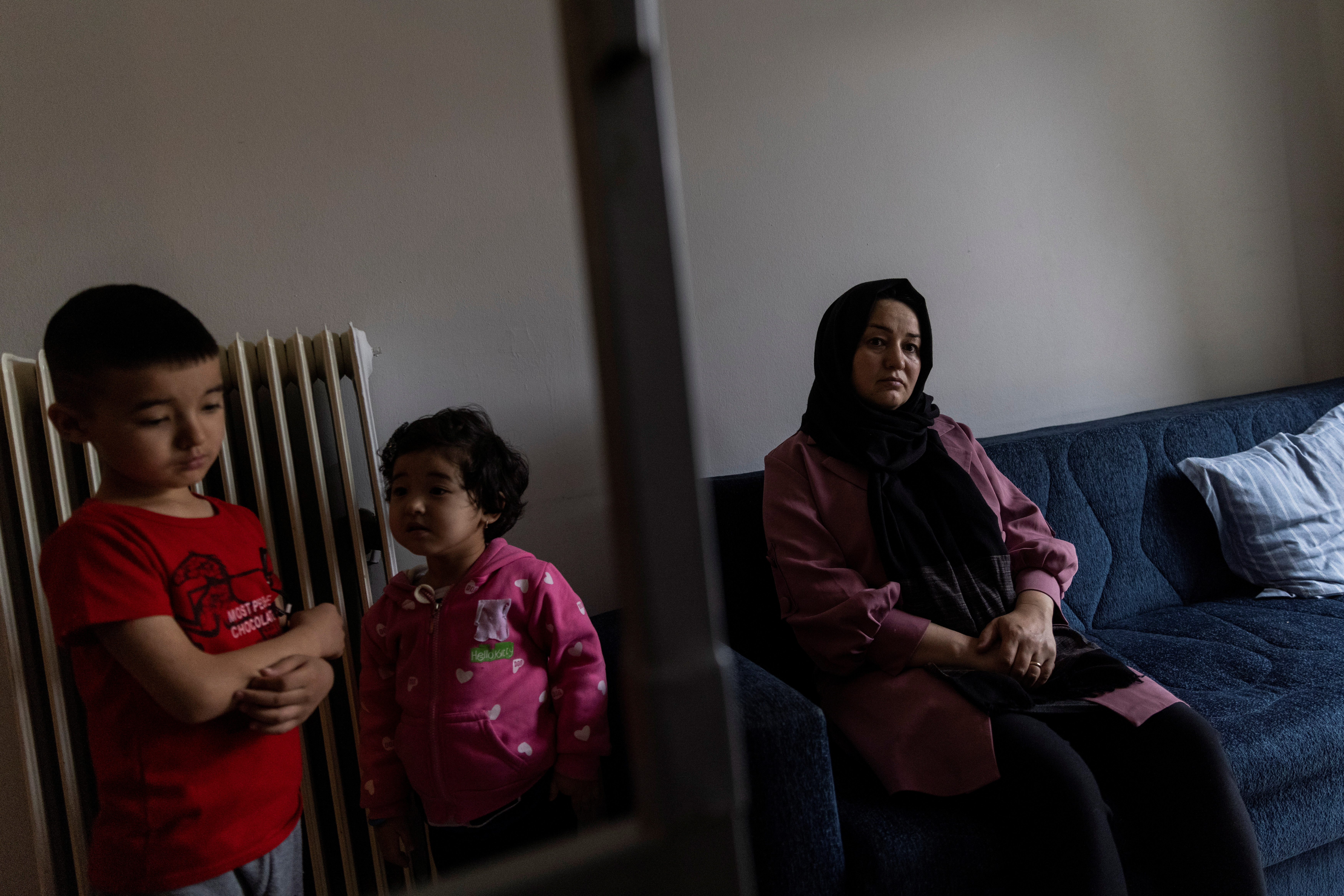 Afghan lawyer Bibi Chaman Hafizi and her children Arsheya and Diana are seen in the living room of their apartment in Athens