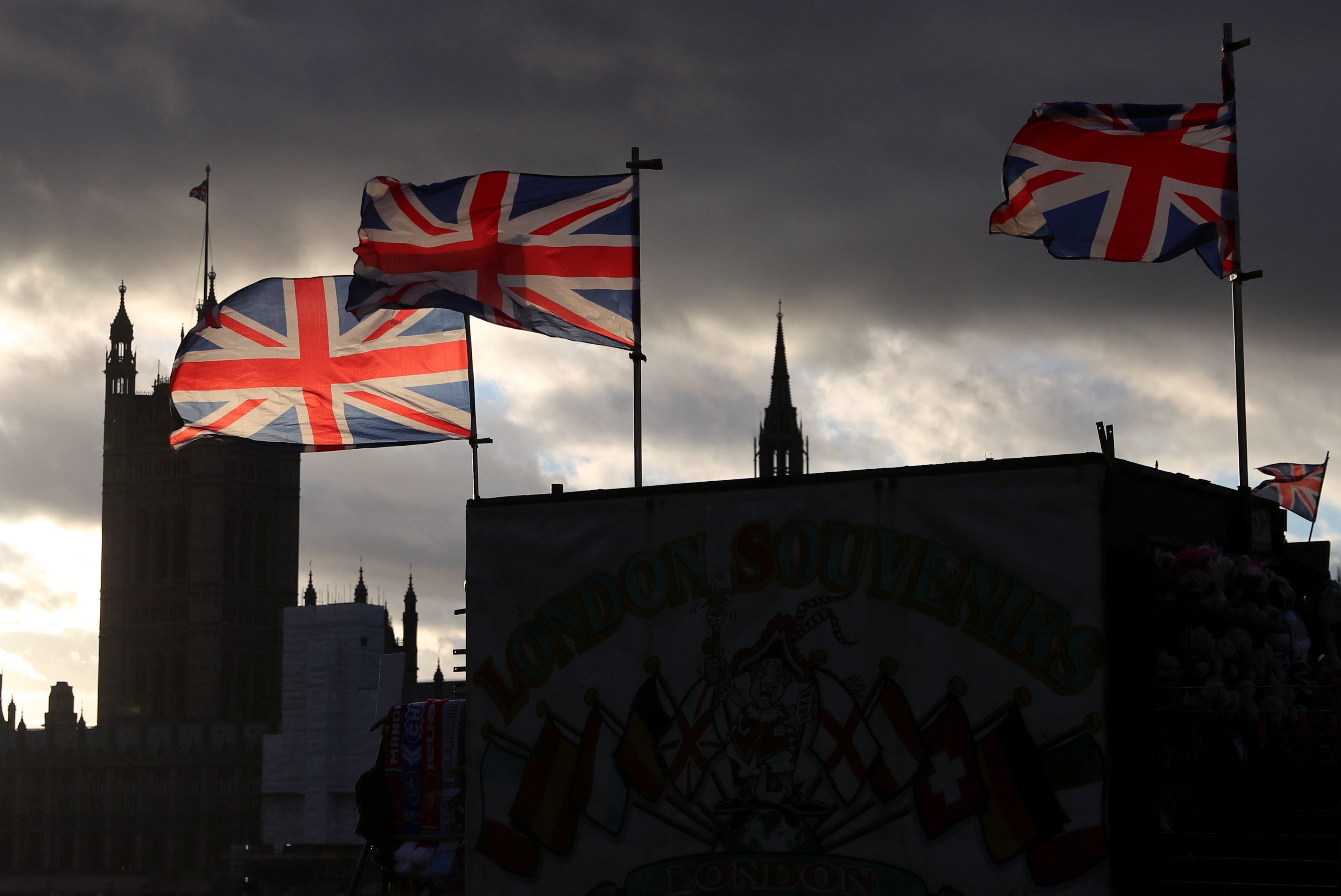 Union Jack flags fly in the wind in front of the Parliament at Westminster bridge, in London