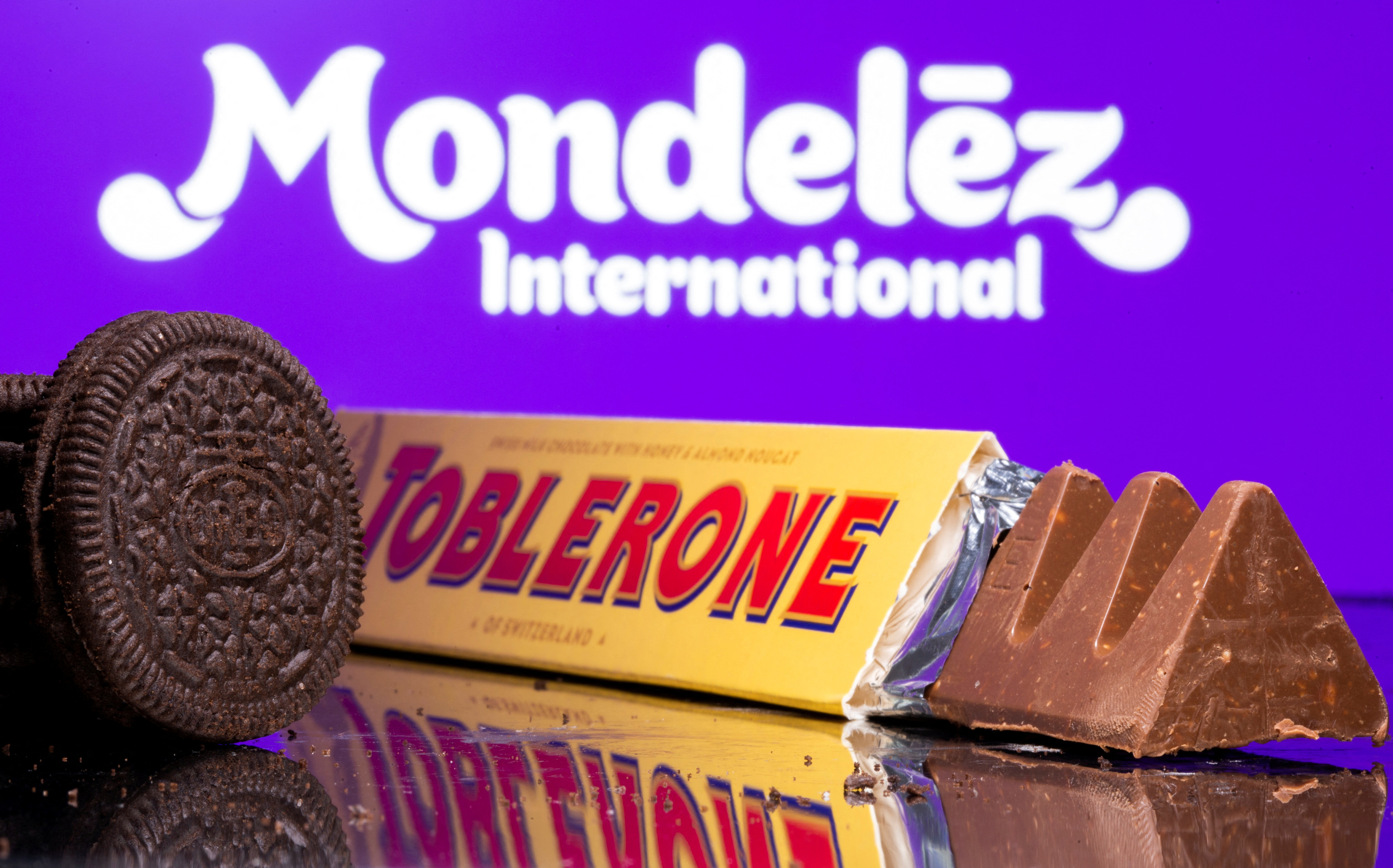 Oreo biscuits and a Toblerone Swiss milk chocolate are seen displayed in front of Mondelez International logo in this illustration picture