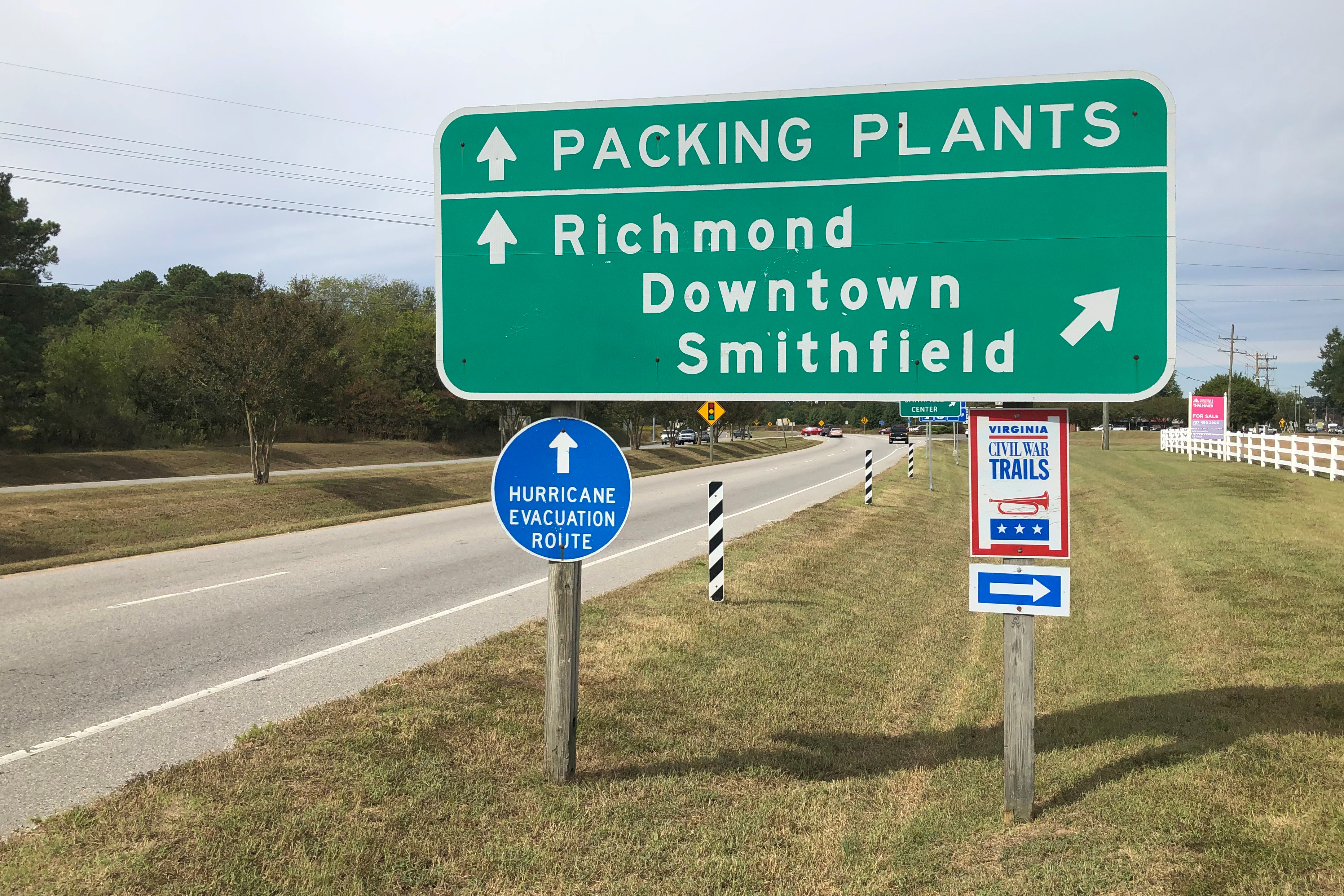 A road sign directs traffic to Smithfield Foods' pork processing facilities in Smithfield