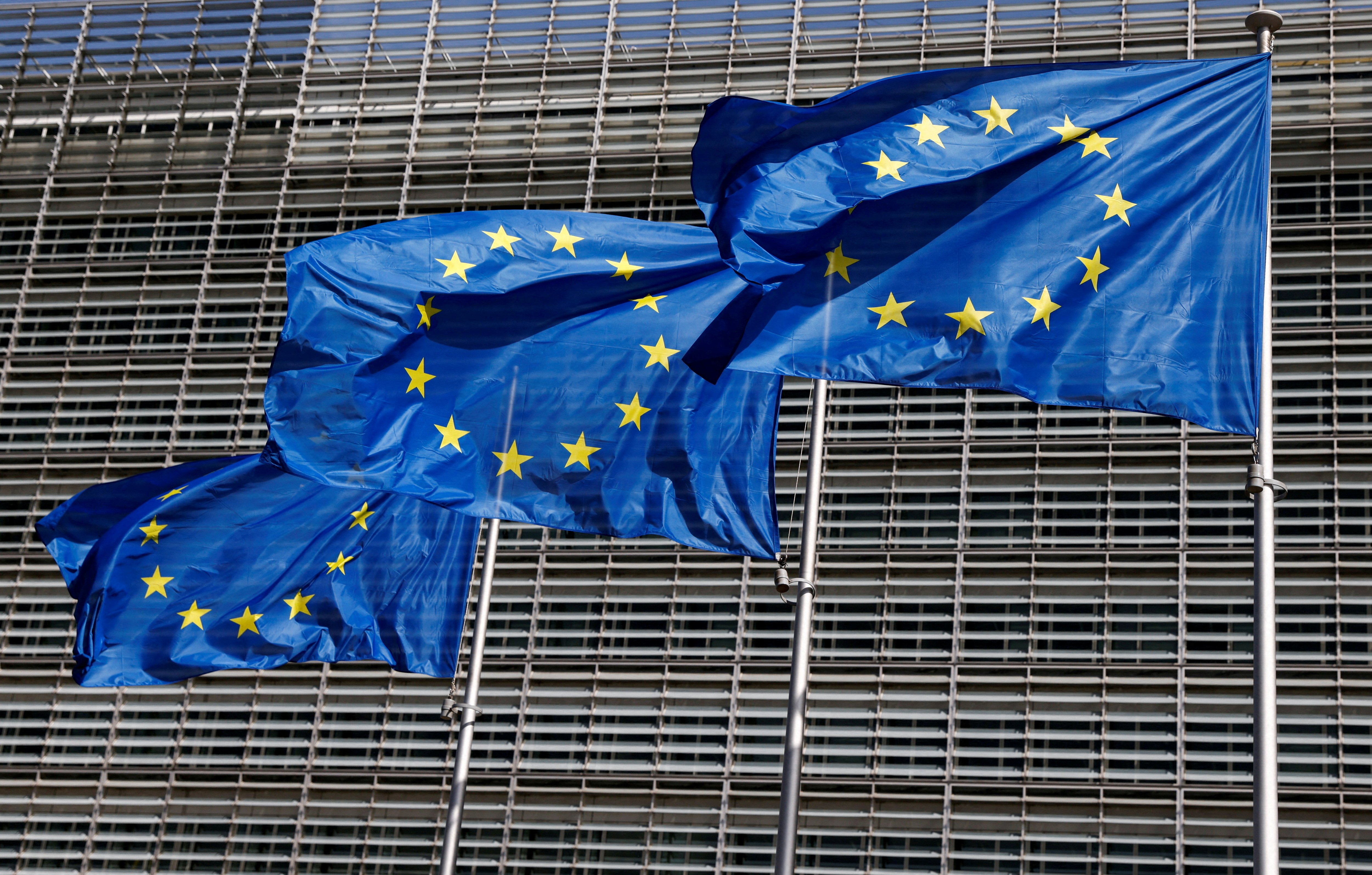 Flagi Unii Europejskiej powiewają przed siedzibą Komisji Europejskiej w Brukseli