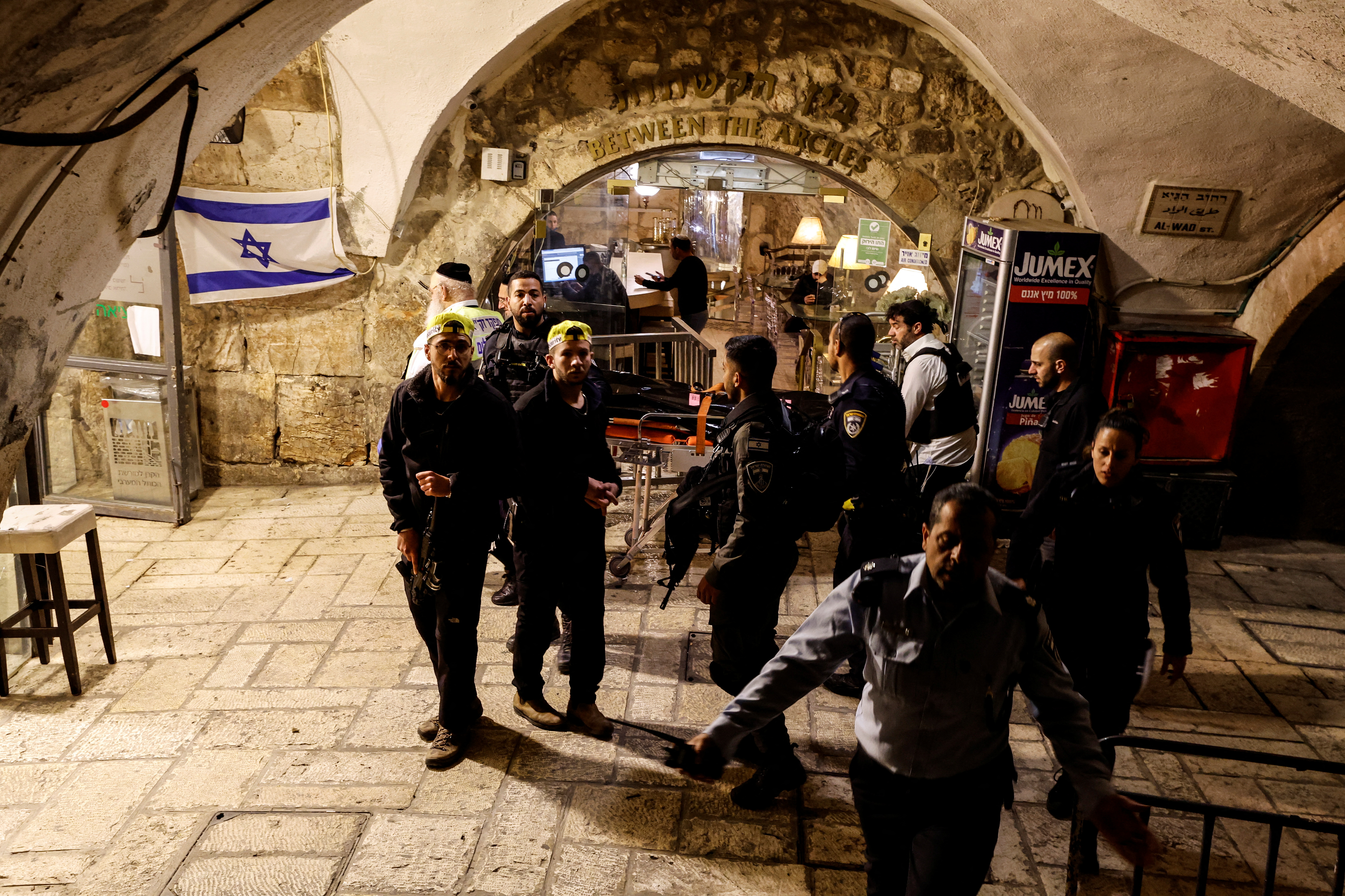 Israeli rescue workers carry a dead body at the scene following an incident inside Jerusalem's Old city