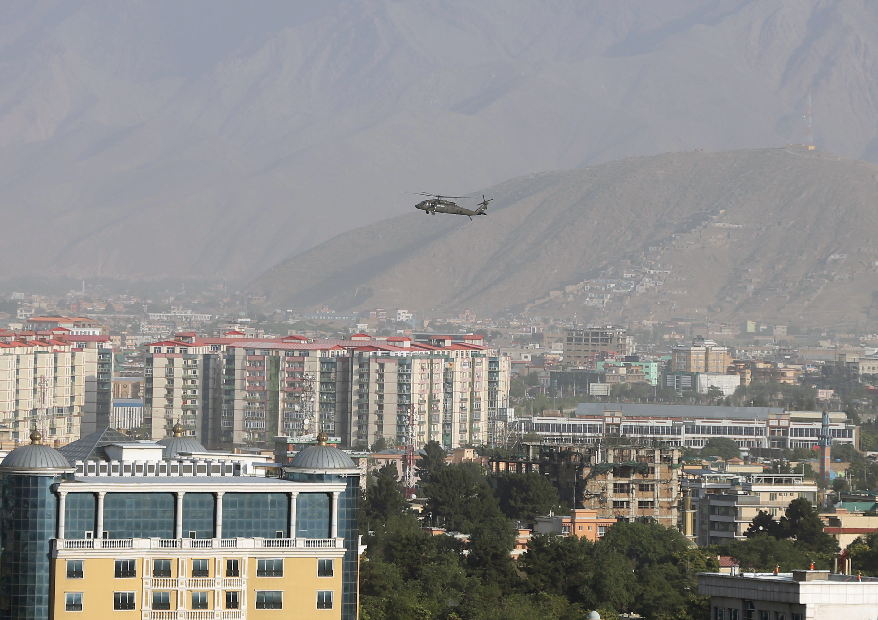 A NATO helicopter flies over the city of Kabul, Afghanistan