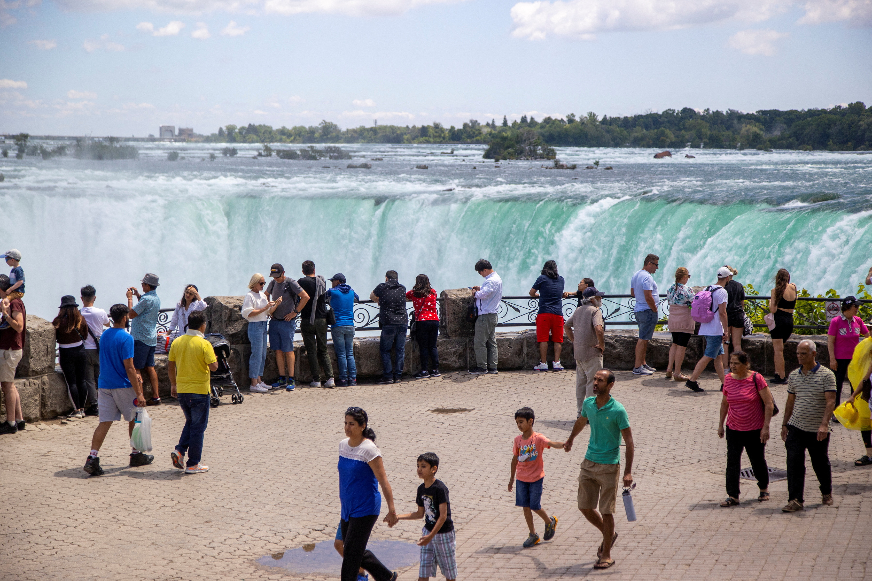 Tourist take photos in front of the Horsehoe Falls in Niagara Falls
