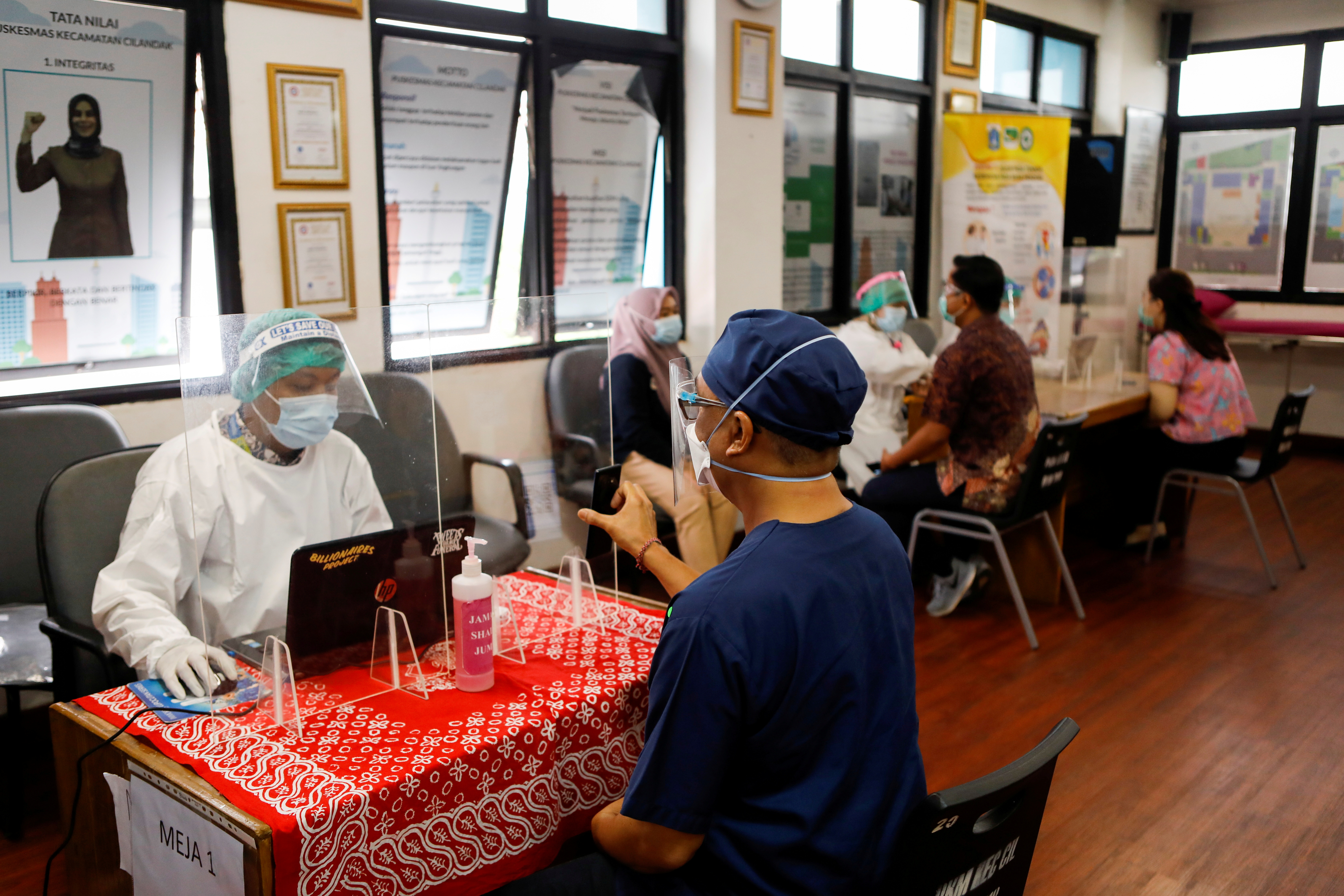 COVID infections imperil Indonesia's vaccinated health workers, and  hospitals | Reuters