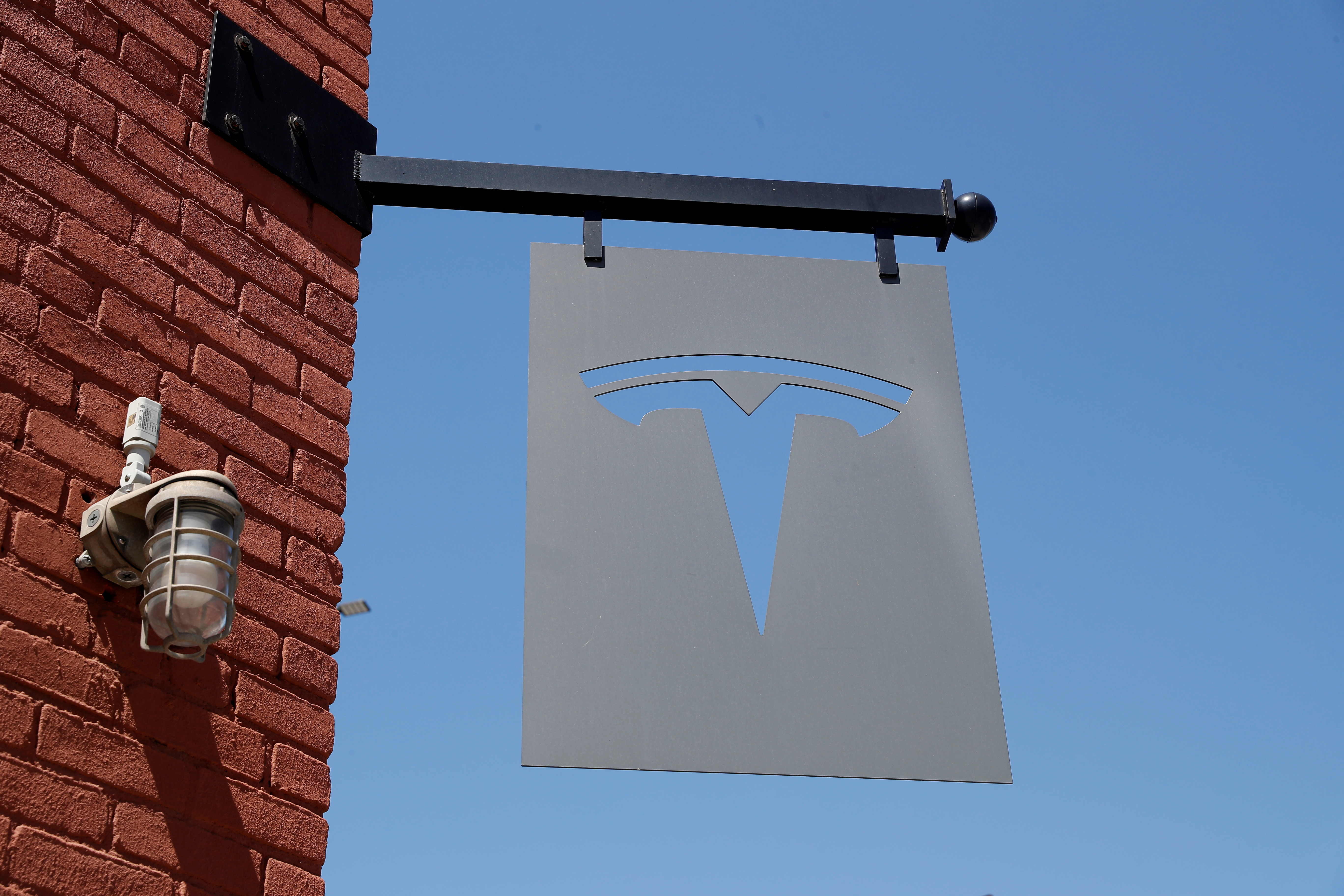 The TESLA logo is seen outside a dealership in the Brooklyn borough of New York City