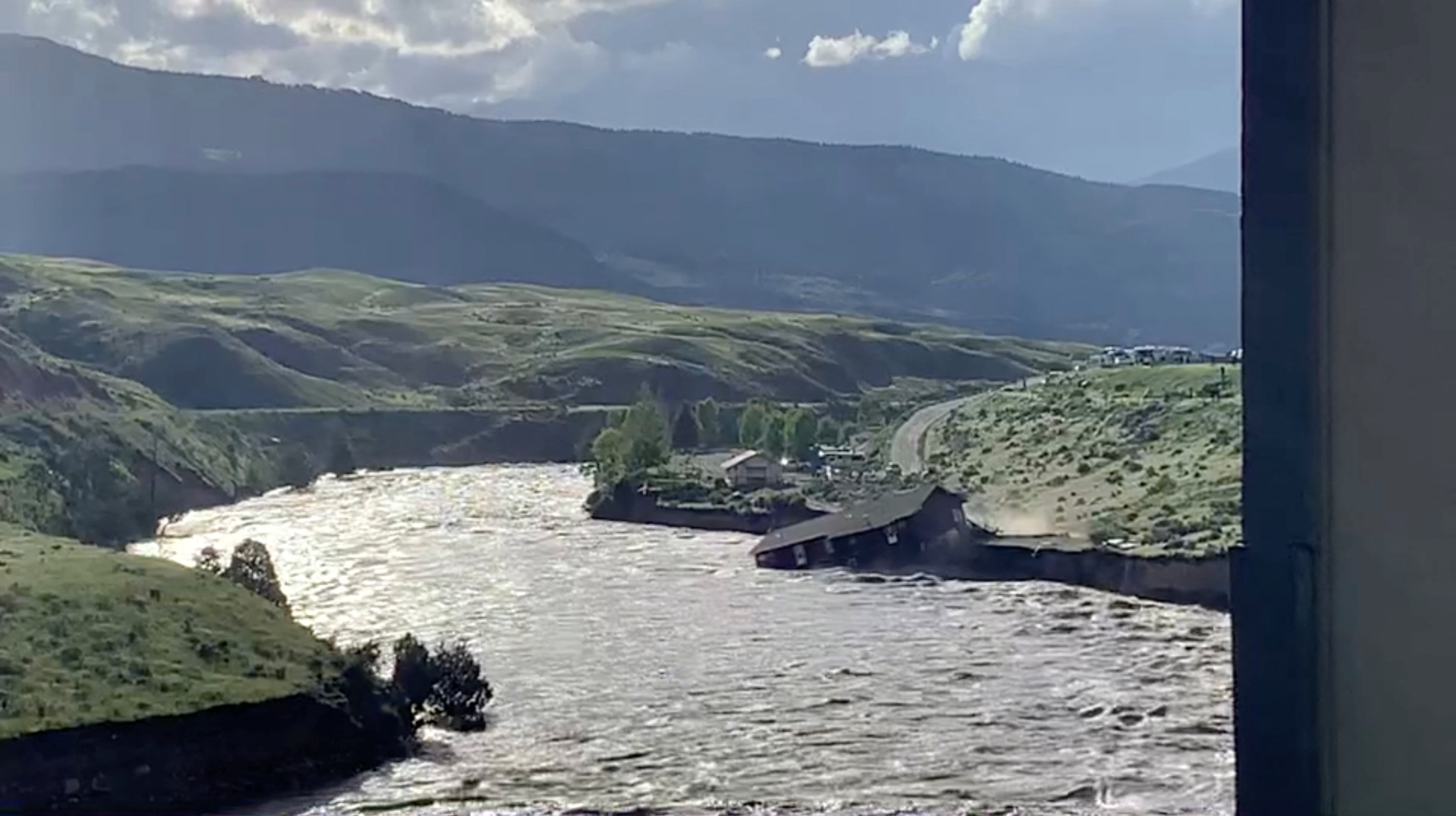 A house falls into the Yellowstone river due to flooding in Gardiner, Montana