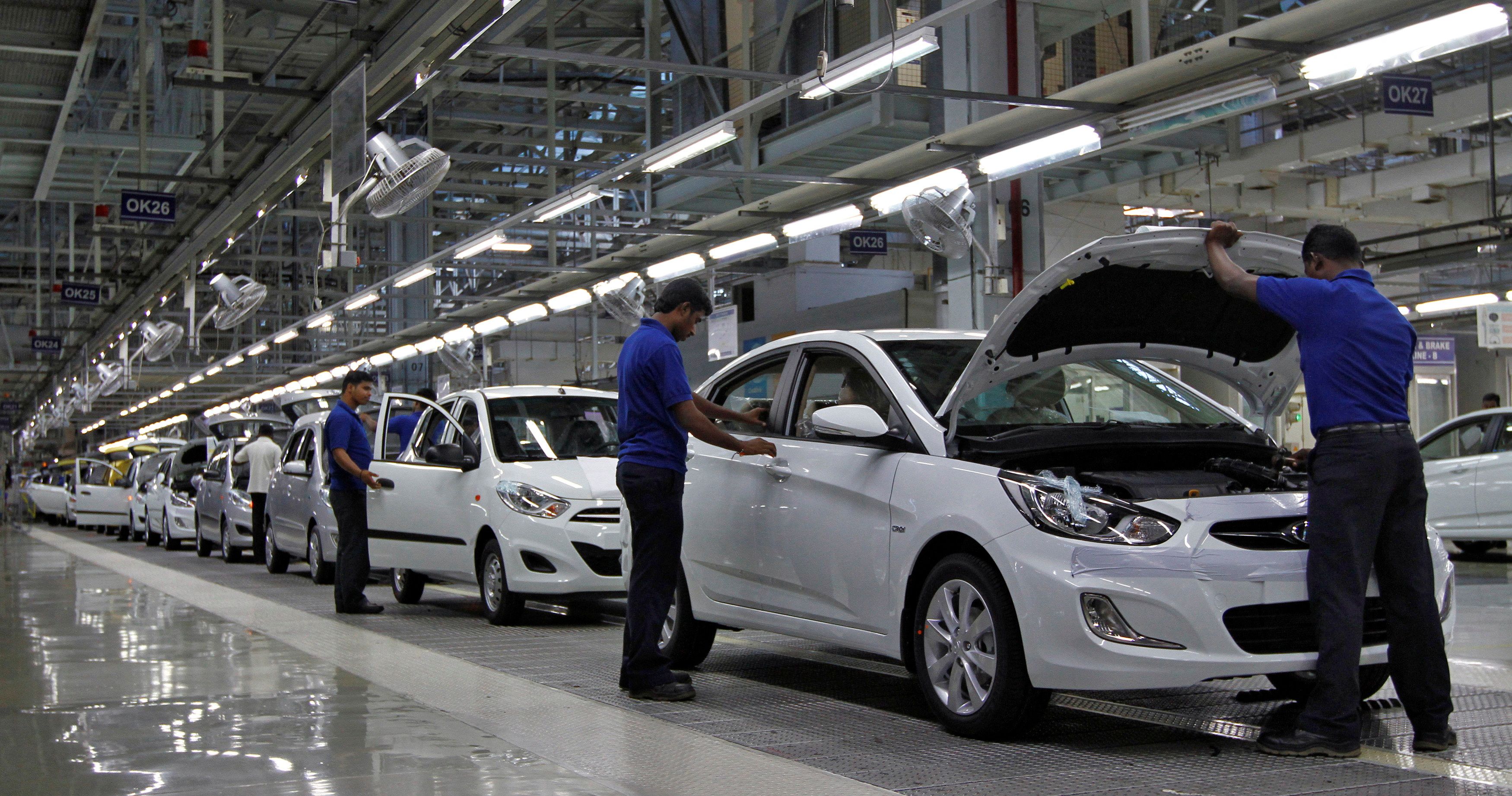 Workers assemble cars inside the Hyundai Motor India Ltd. plant at Kancheepuram district in Tamil Nadu