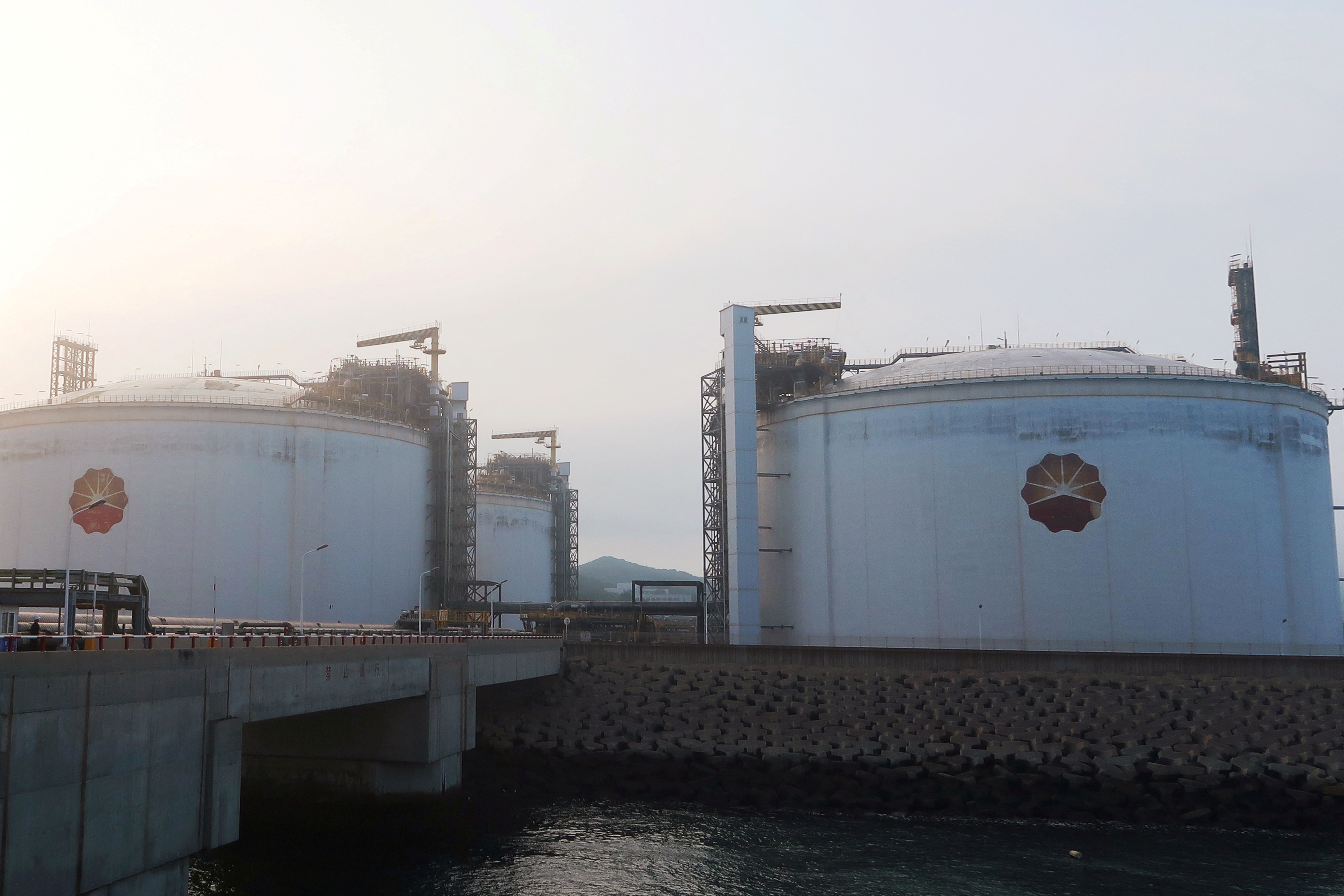 Liquified natural gas (LNG) storage tanks are seen at PetroChina's receiving terminal in Dalian