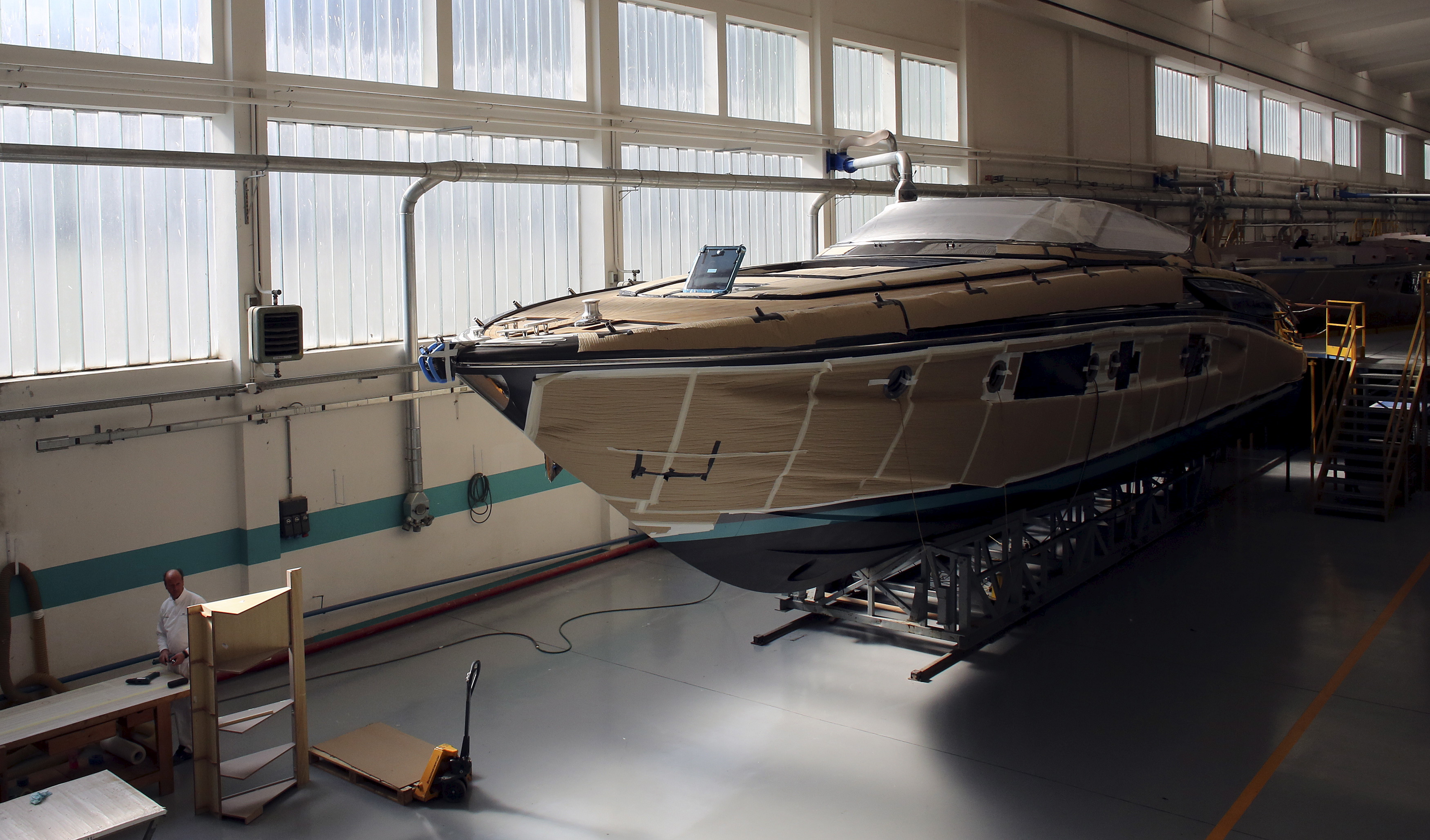 An employee works on a yacht at the Ferretti's shipyard in Sarnico