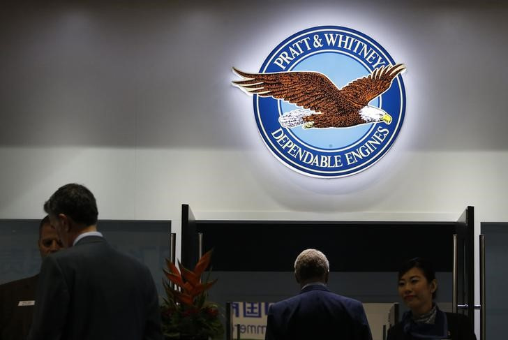 The logo of U.S. manufacturer Pratt & Whitney is seen  as people visit the company's booth at the Singapore Airshow at Changi Exhibition Center