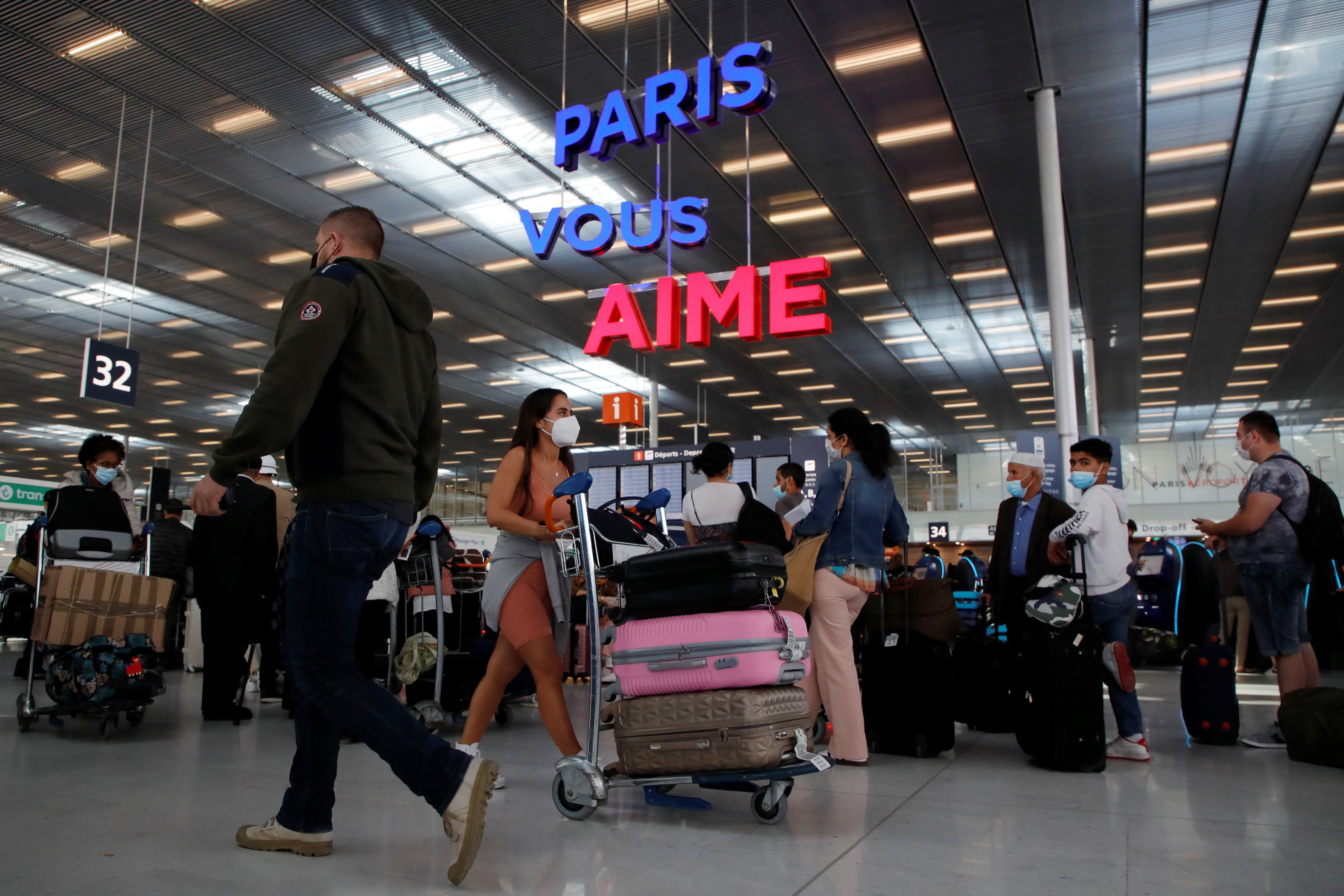 Passengers line up to check in at Orly Airport