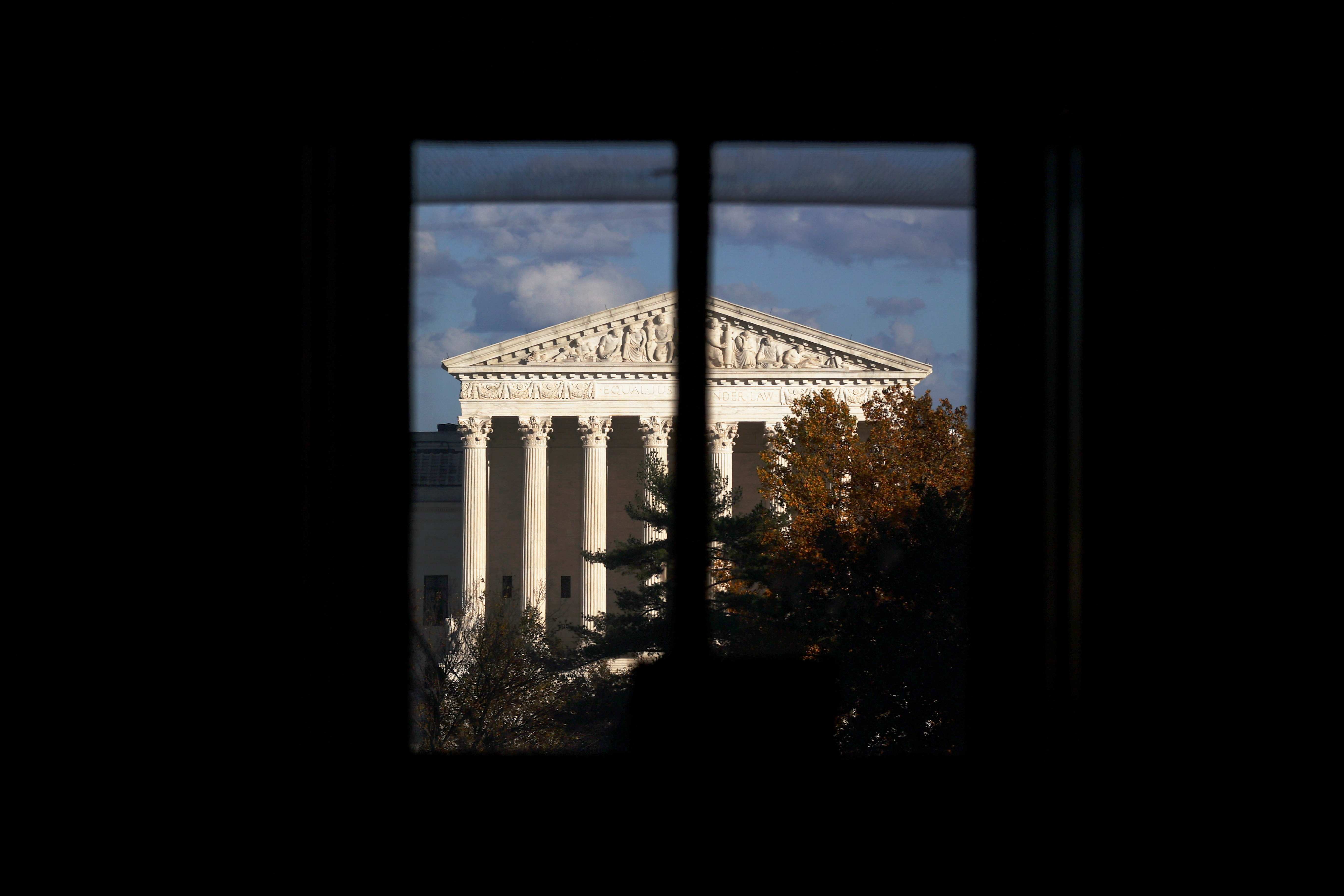 The U.S. Supreme Court building is seen behind a window in Washington, U.S. November 10, 2020. REUTERS/Hannah McKay