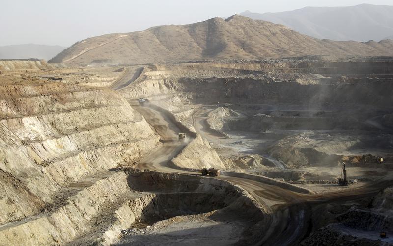 Trucks ferry excavated gold, copper and zinc ore from the main mining pit at the Bisha Mining Share Company northwest of Eritrea's capital Asmara