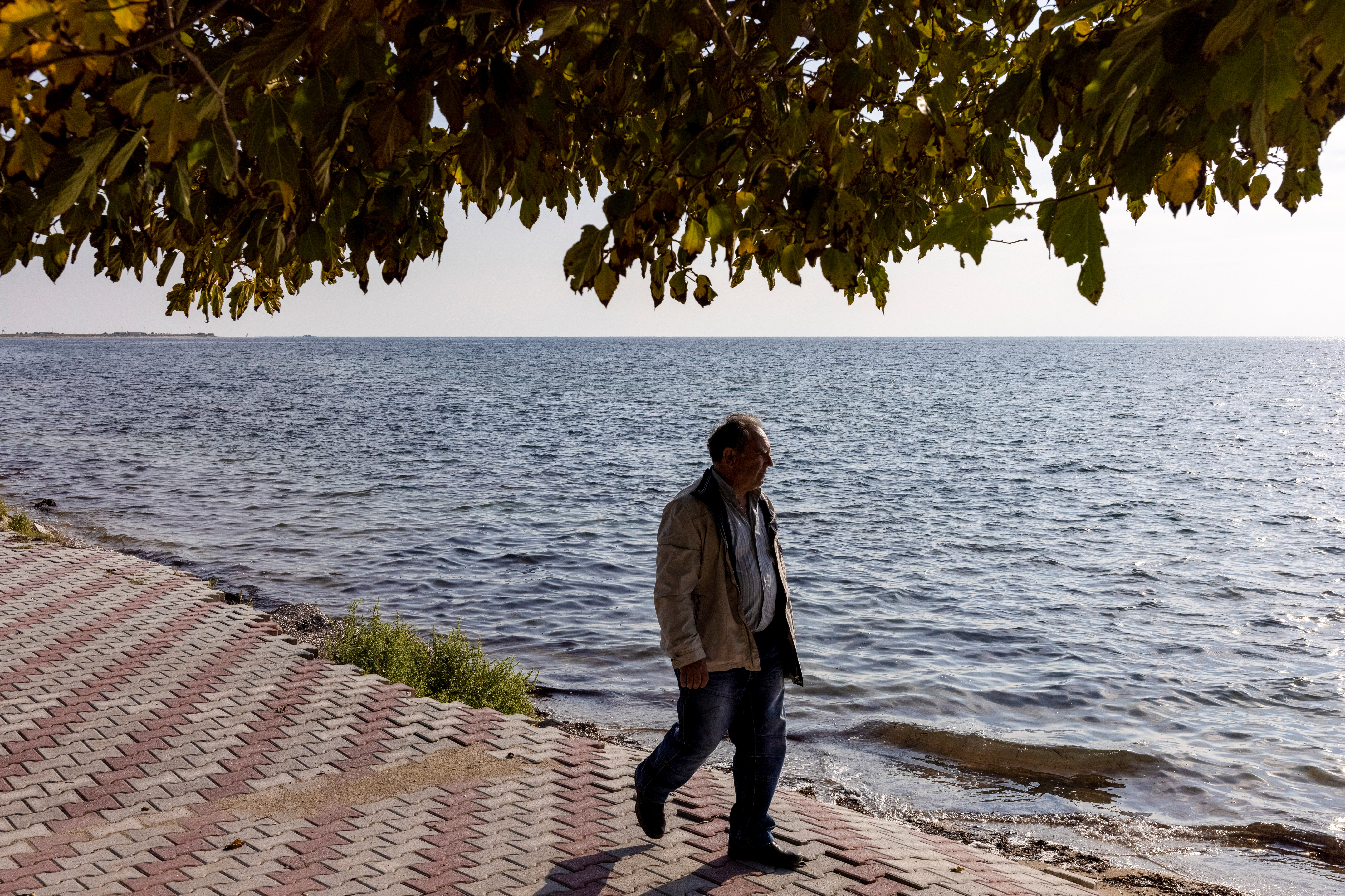 Local George Perperis walks on the damaged pedestrian street of the seaside village of Nea Irakleia, Greece, October 20, 2021. REUTERS/Alkis Konstantinidis