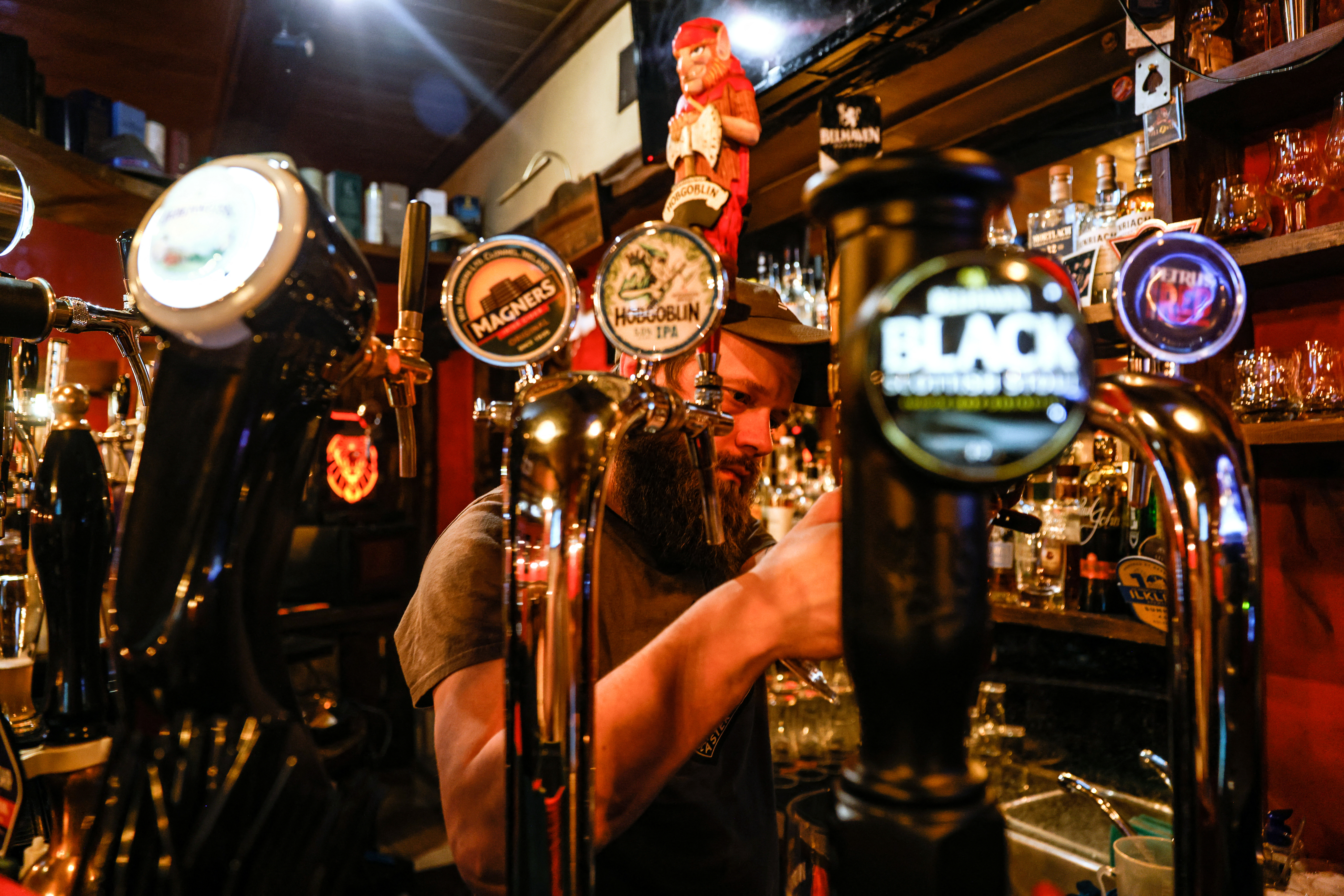 A bartender pours beer at a bar in Moscow