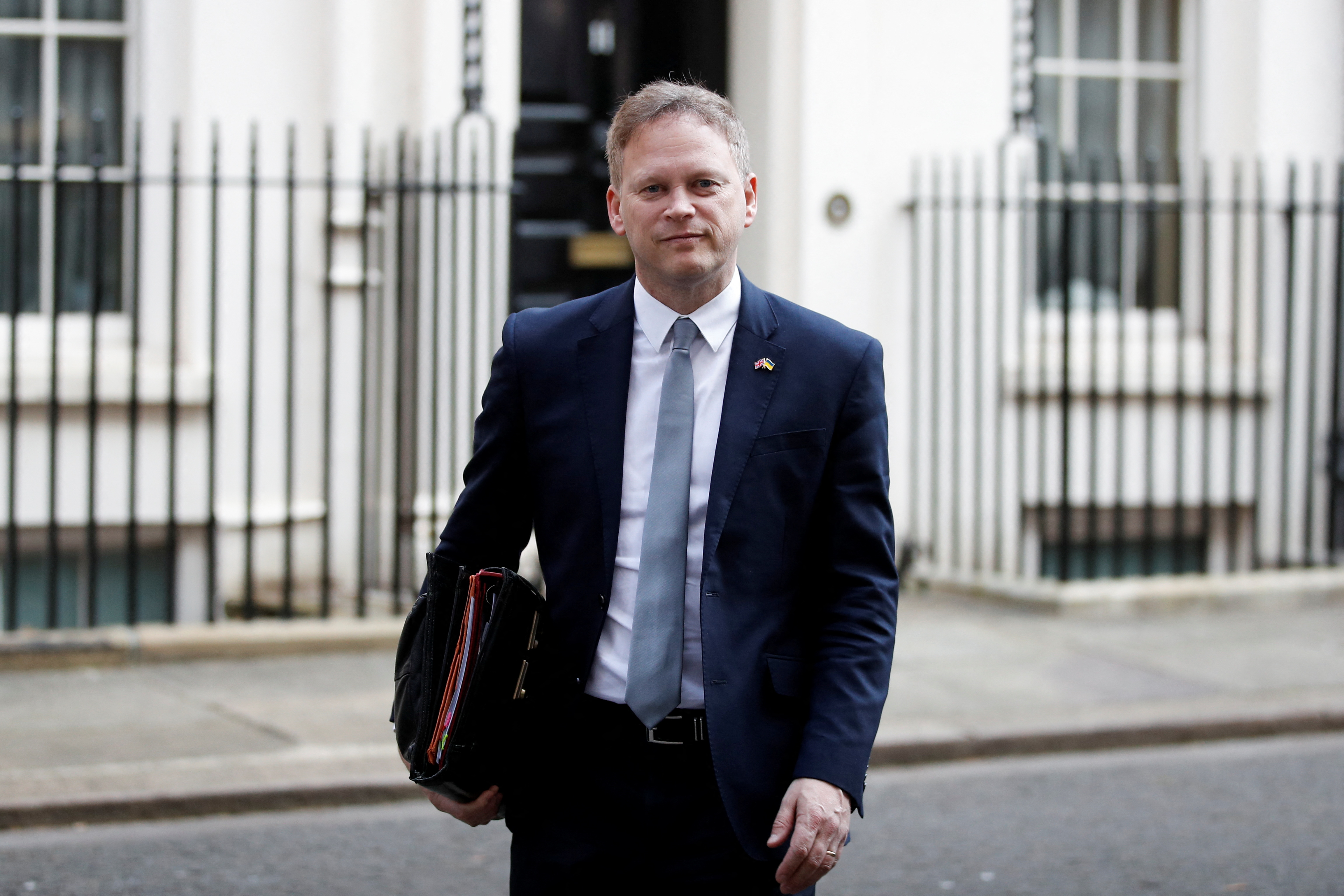 British Transport Secretary Grant Shapps walks outside Downing Street, in London