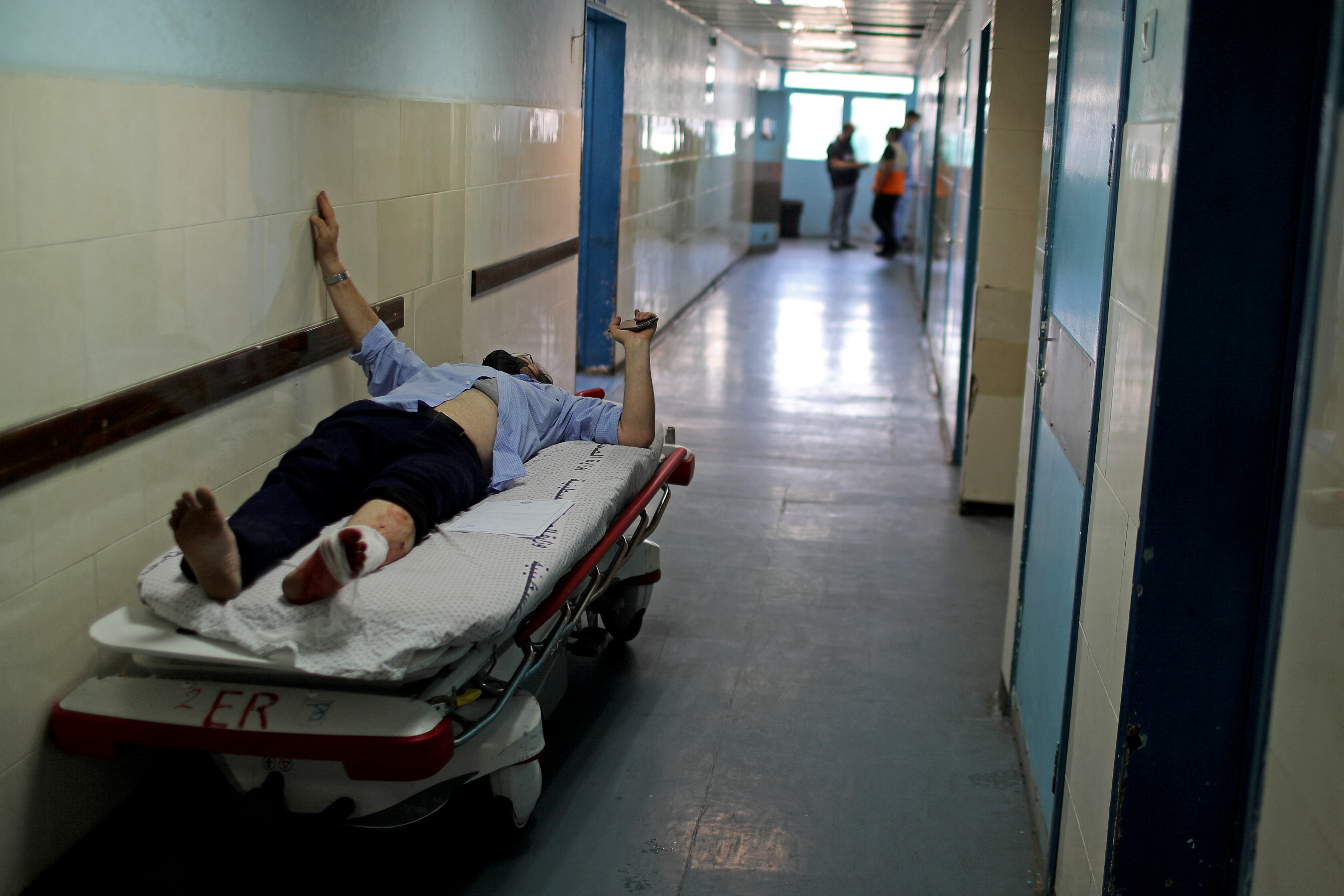 A wounded Palestinian man lies on a bed in Shifa hospital in Gaza City May 17, 2021. REUTERS/Mohammed Salem
