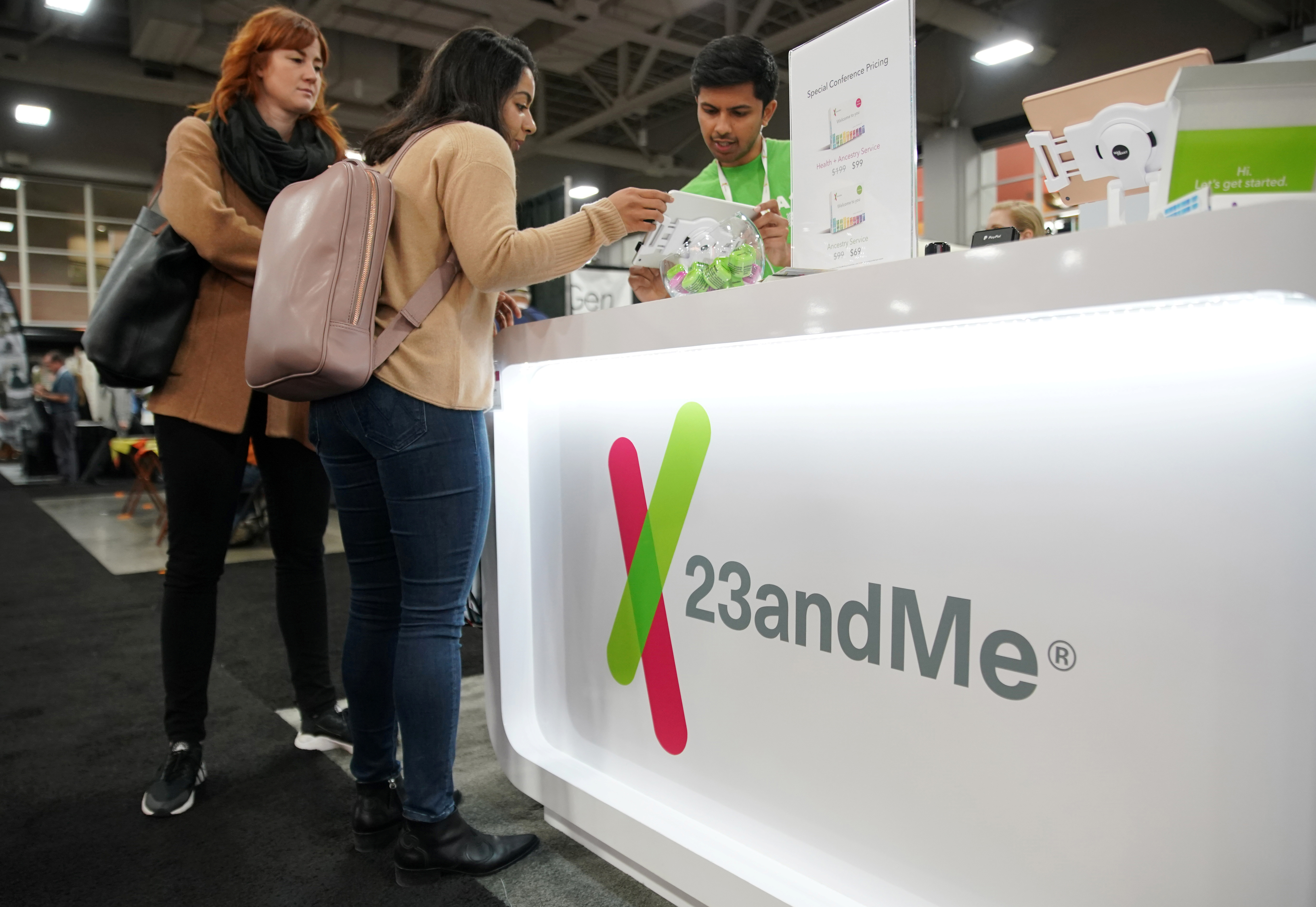 Attendees purchase DNA kits at the 23andMe booth at the RootsTech annual genealogical event in Salt Lake City