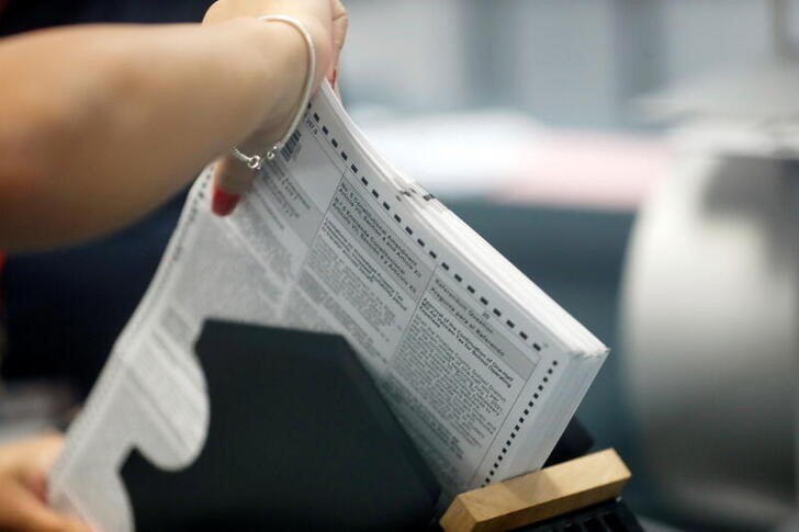 A member of the Pinellas County canvassing board processes ballots on Election Day in Largo, Florida