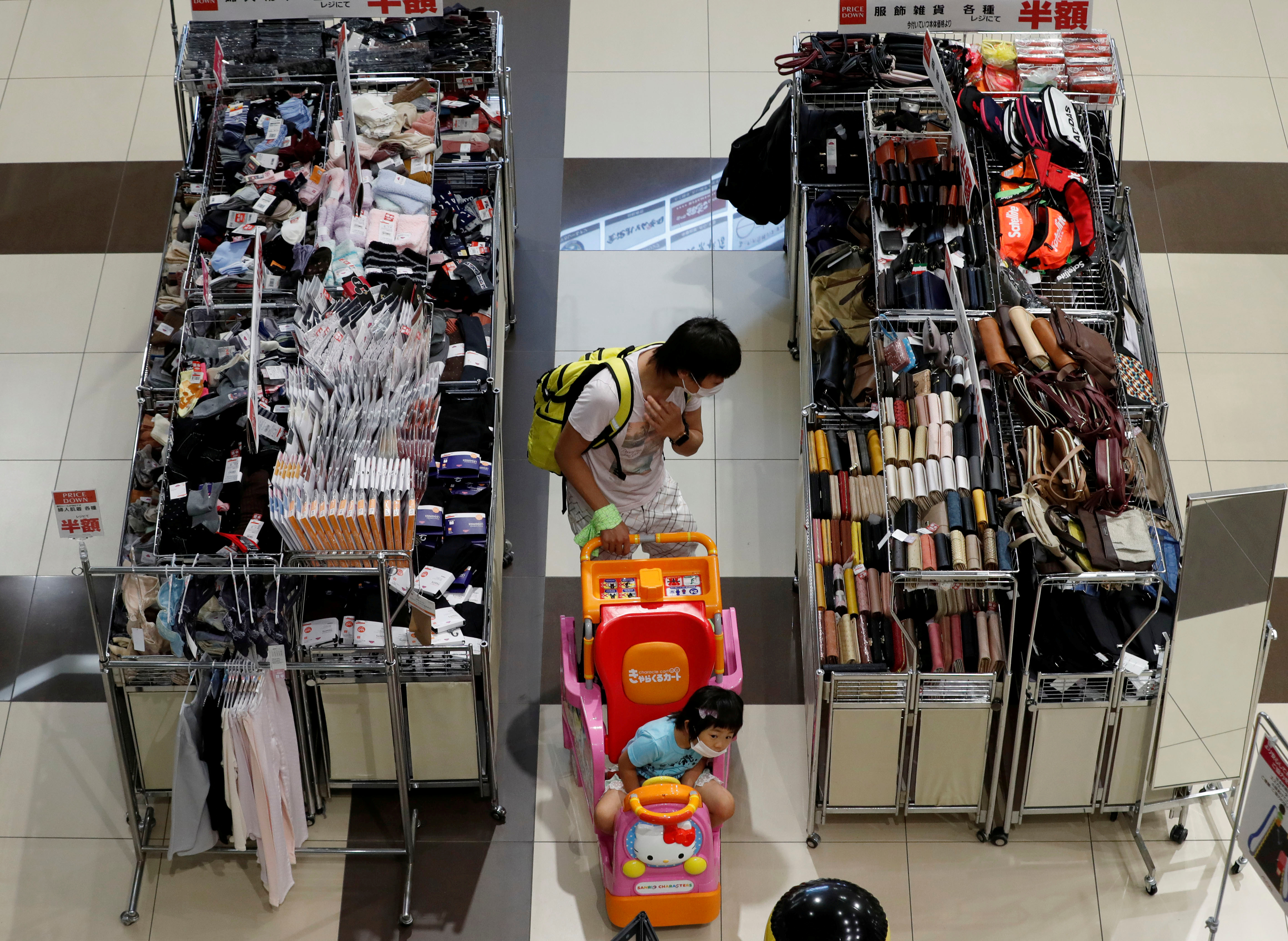A shopper looks at goods at Japan's supermarket group Aeon's shopping mall as the mall reopens amid the coronavirus disease (COVID-19) outbreak in Chiba