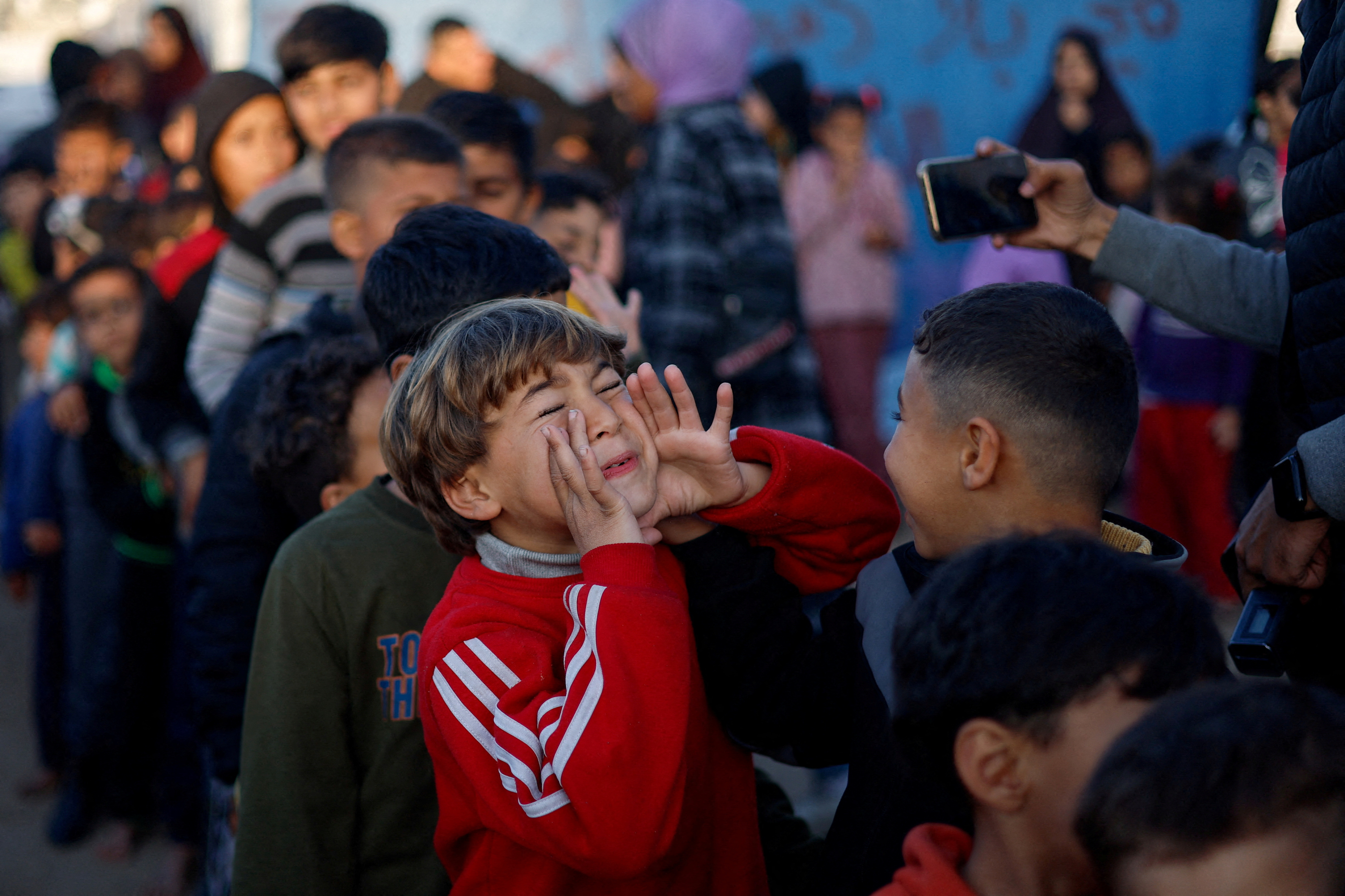 Displaced Palestinian children take part in an entertaining activity organised by local activists at an UNRWA school in Rafah