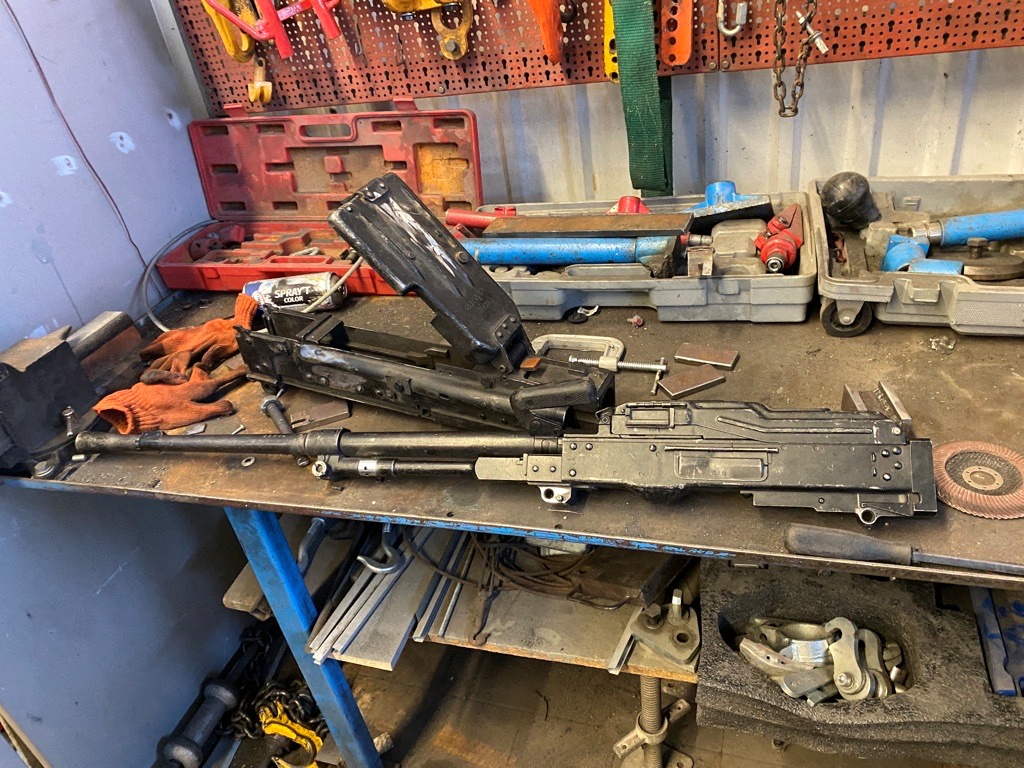 The back of a Kord machine gun, in background, that auto mechanics in Kyiv said was recovered from Russian forces, in Kyiv, Ukraine, April 14, 2022. Etchings on the gun matched those of etchings found on a high-caliber rifle that London-based research group Conflict Armament Research examined in Ukraine in 2018 and determined was produced at the Degtyarev plant.       REUTERS/Sergiy Karazy