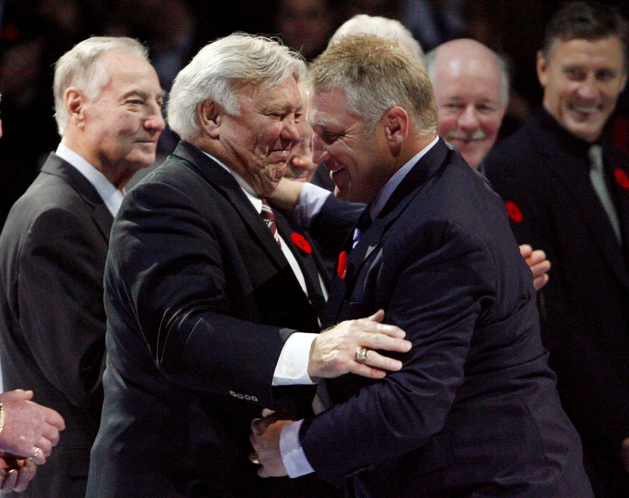 Former NHL star Hull embraces his son Brett during an on-ice ceremony to introduce the Hockey Hall of Fame 2009 inductees in Toronto