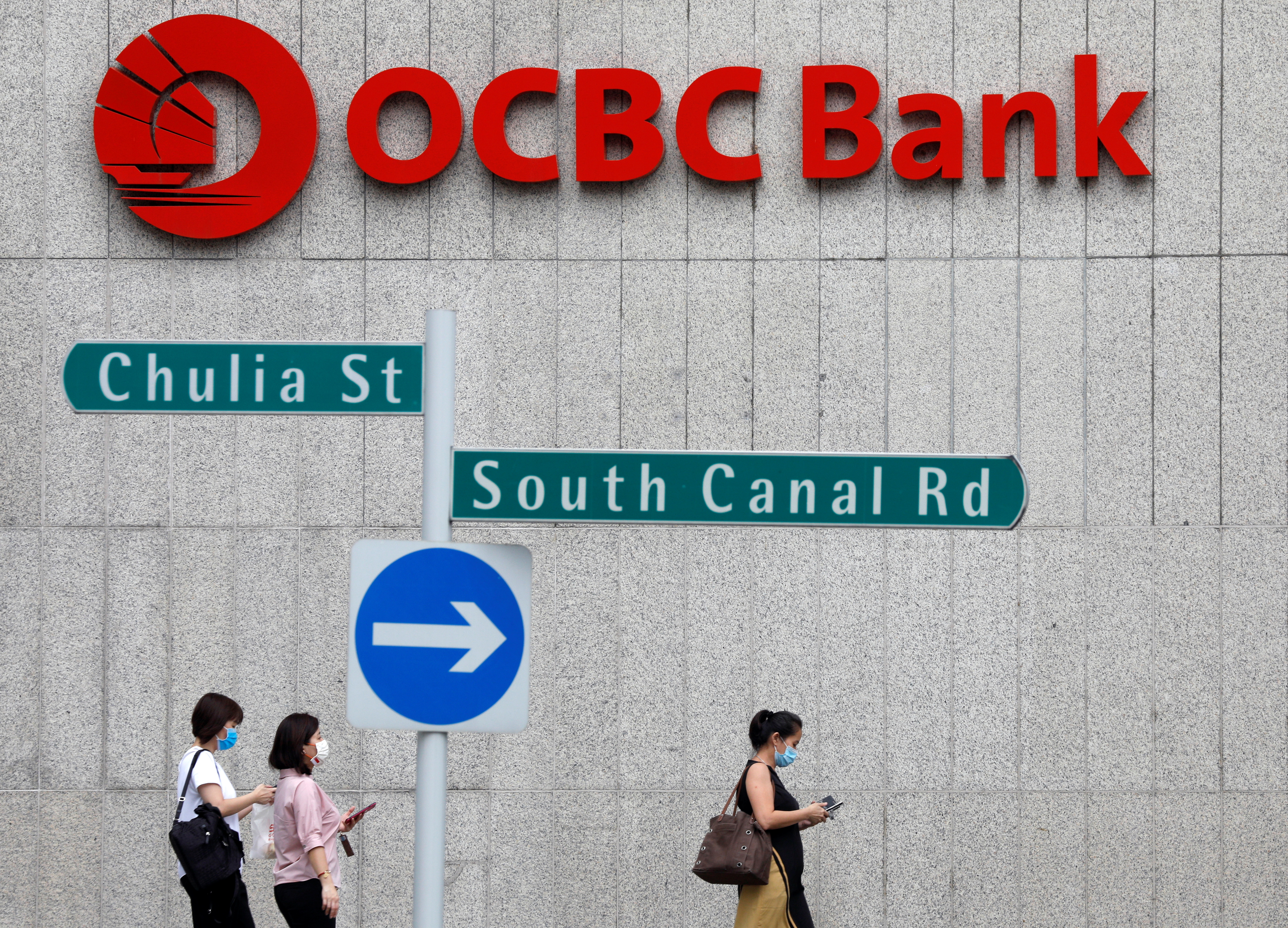 People pass by an OCBC bank branch in Singapore