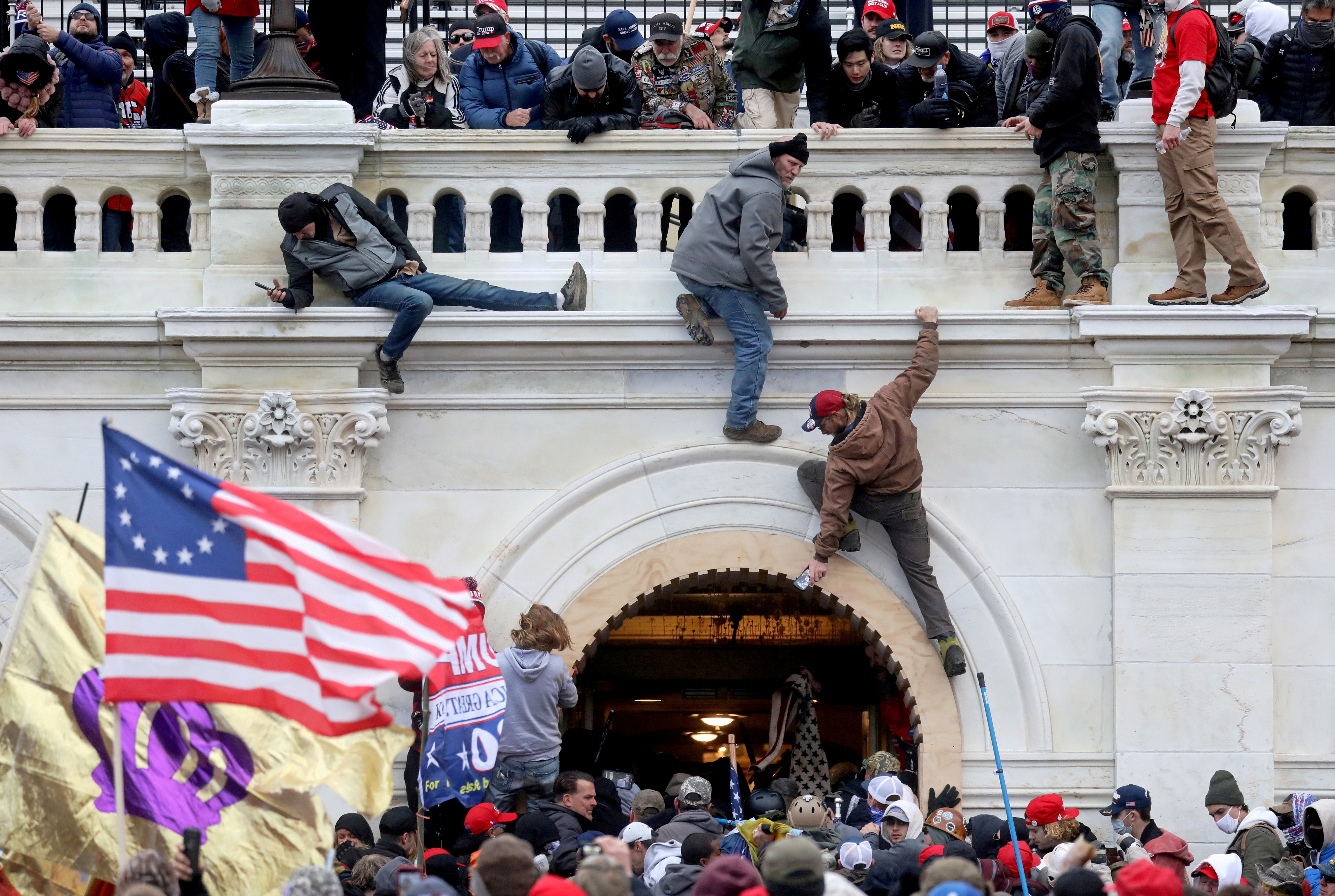 A mob of supporters of U.S. President Donald Trump fight with members of law enforcement at a door they broke open as they storm the U.S. Capitol Building in Washington, U.S., January 6, 2021. REUTERS/Leah Millis/File Photo