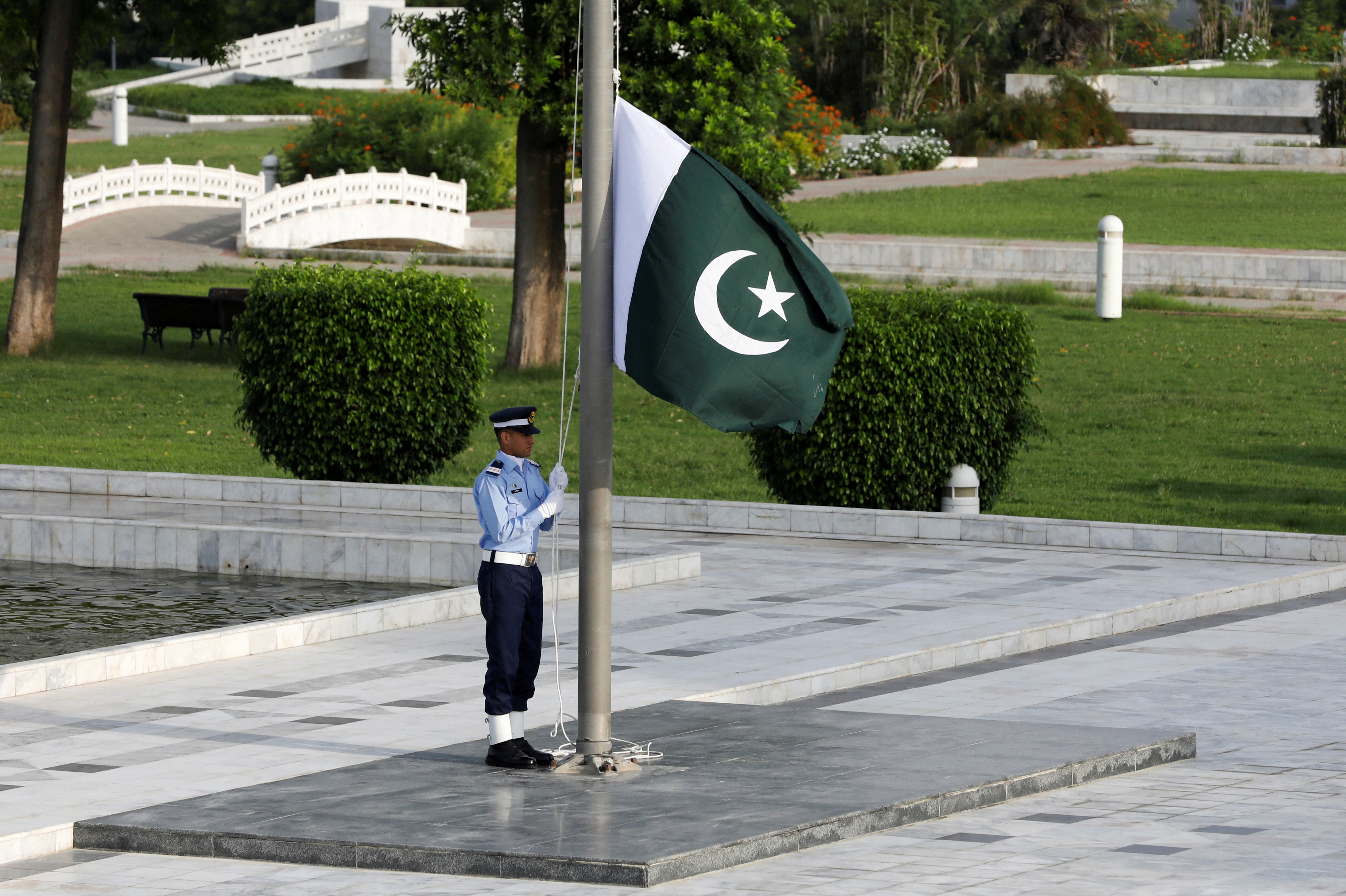A member of the Pakistan Air Force (PAF) rehearses flag masting at the mausoleum of Muhammad Ali Jinnah before the Defence Day ceremonies, or Pakistan's Memorial Day, in Karachi