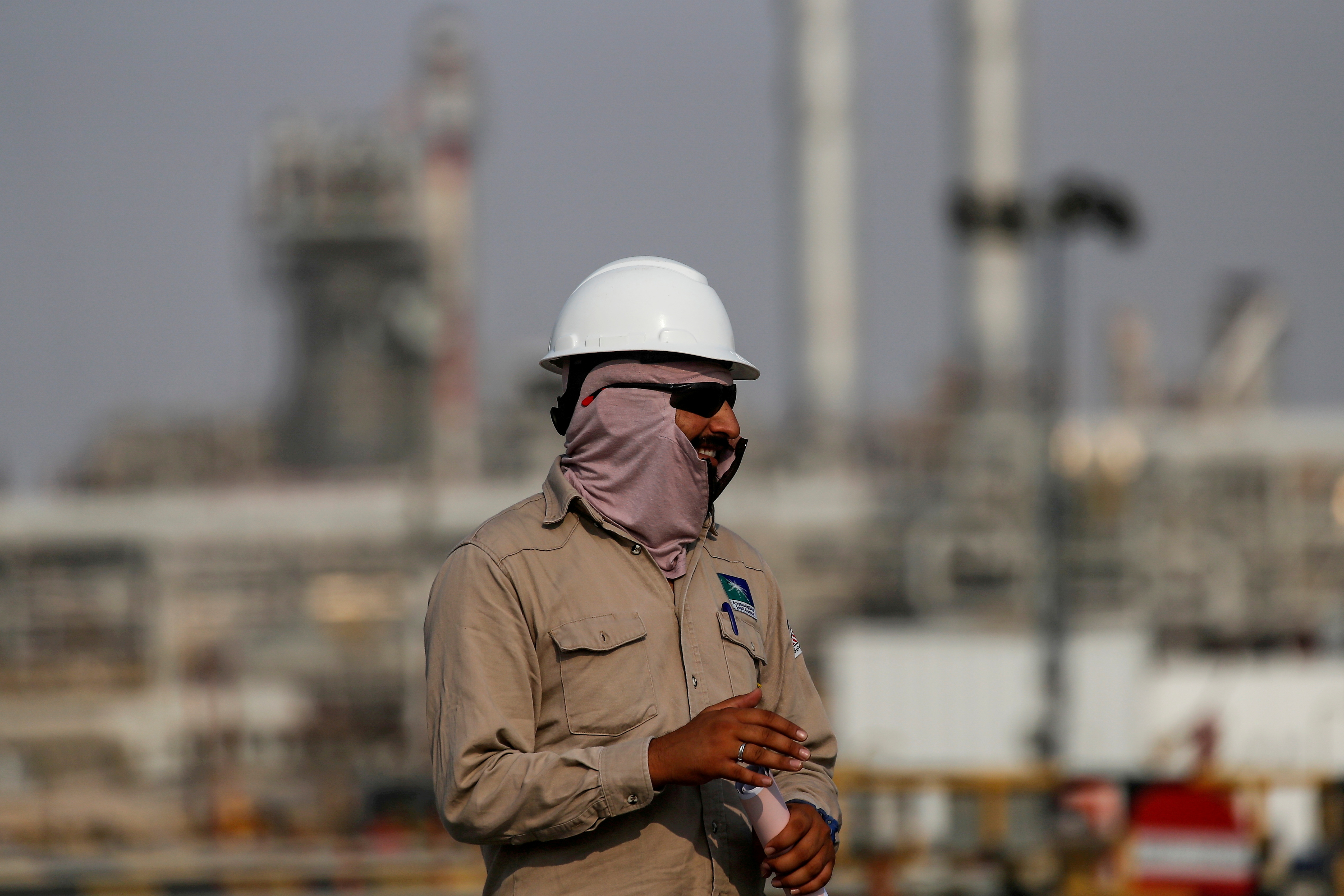 An employee looks on at Saudi Aramco oil facility in Abqaiq