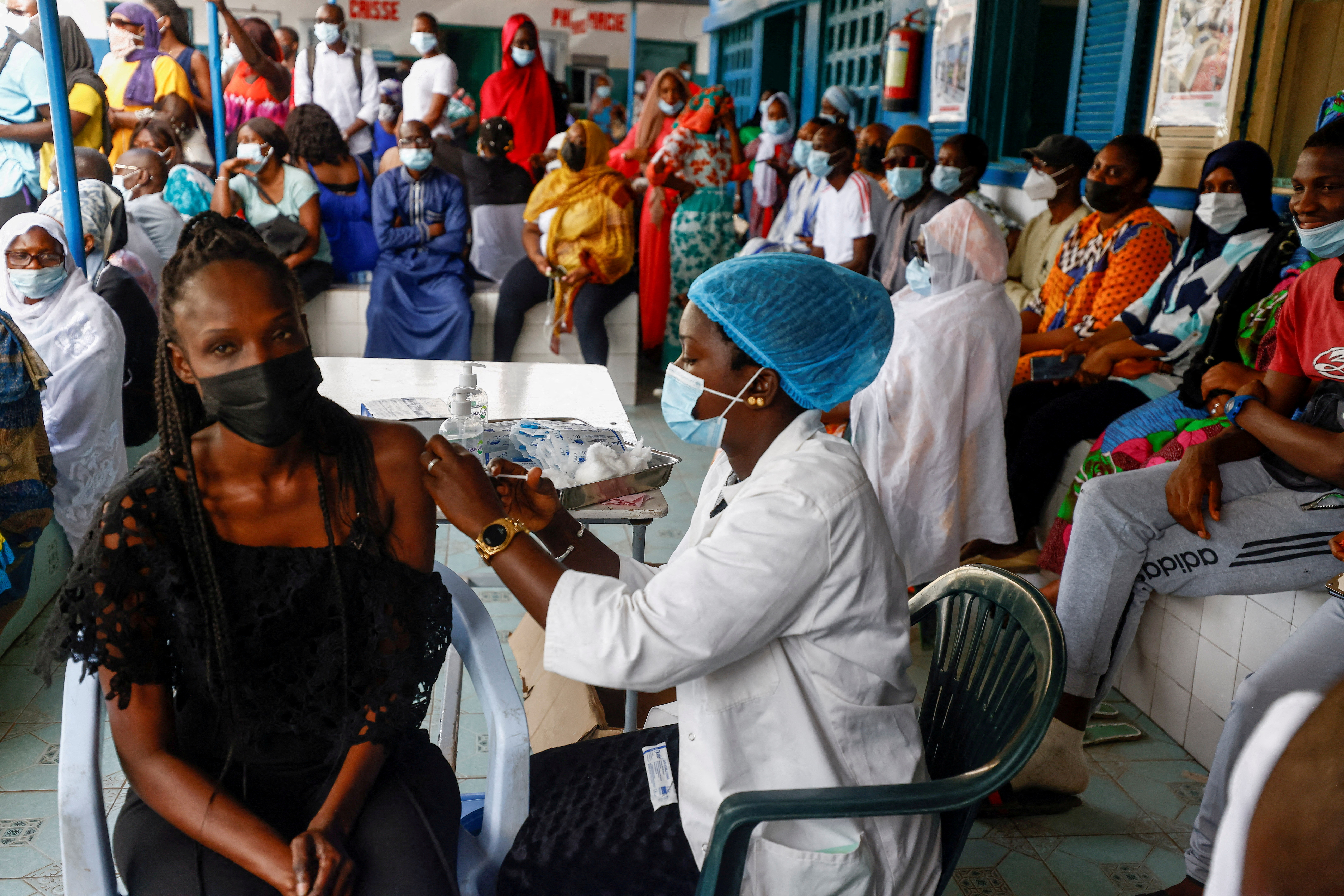 Aminata Laye Diagne, a nurse gives a dose of coronavirus disease (COVID-19) vaccine to a woman at Philippe Senghor Hospital  in Dakar, amid a surge of coronavirus disease (COVID-19) cases in Senegal July 28, 2021. REUTERS/Zohra Bensemra
