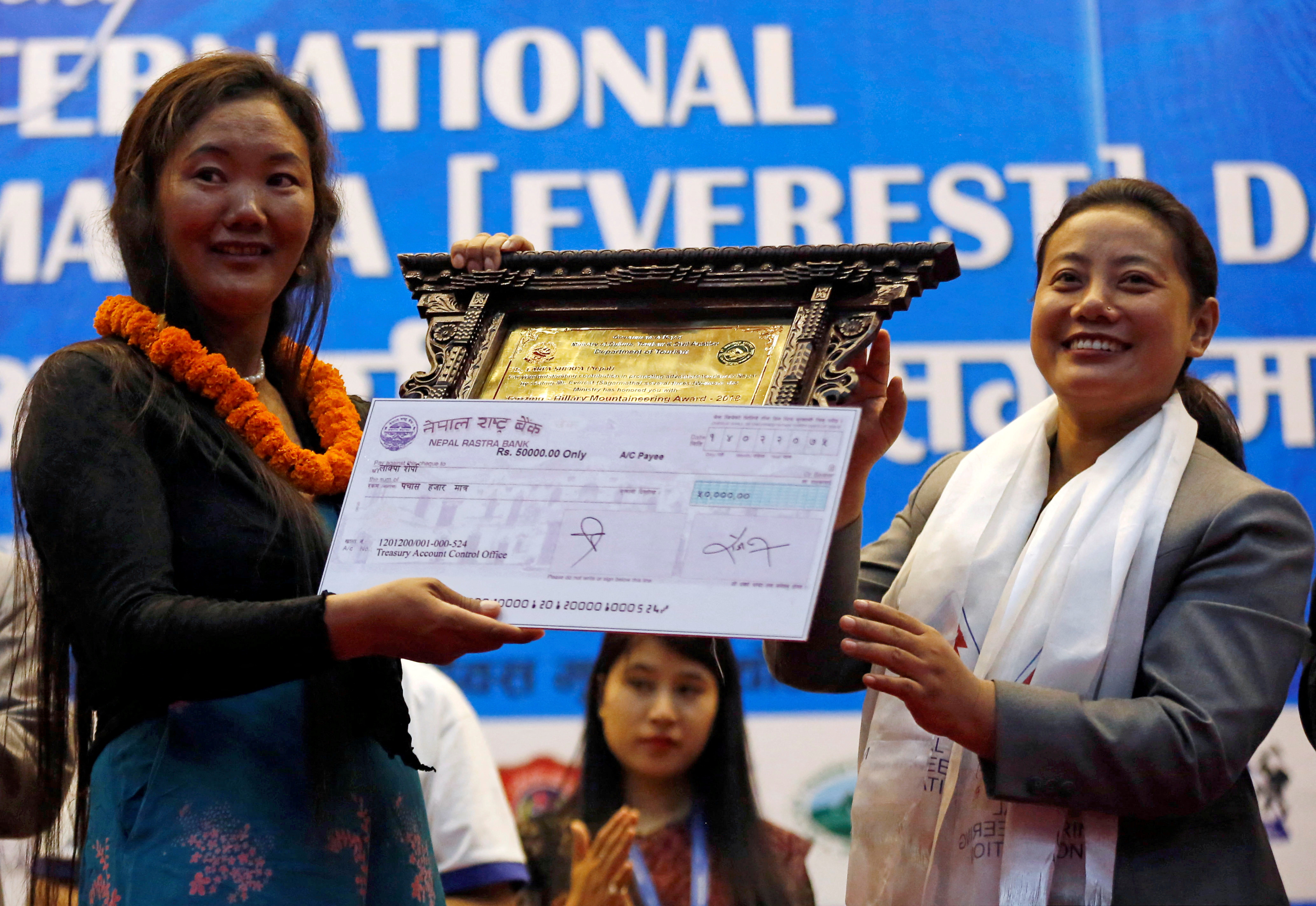 Lhakpa Sherpa, 44, a Nepali mountaineer who climbed Mount Everest 9 times, receives Tenzing Ð Hillary Mountaineering Award during the function to mark the International Everest day in Kathmandu
