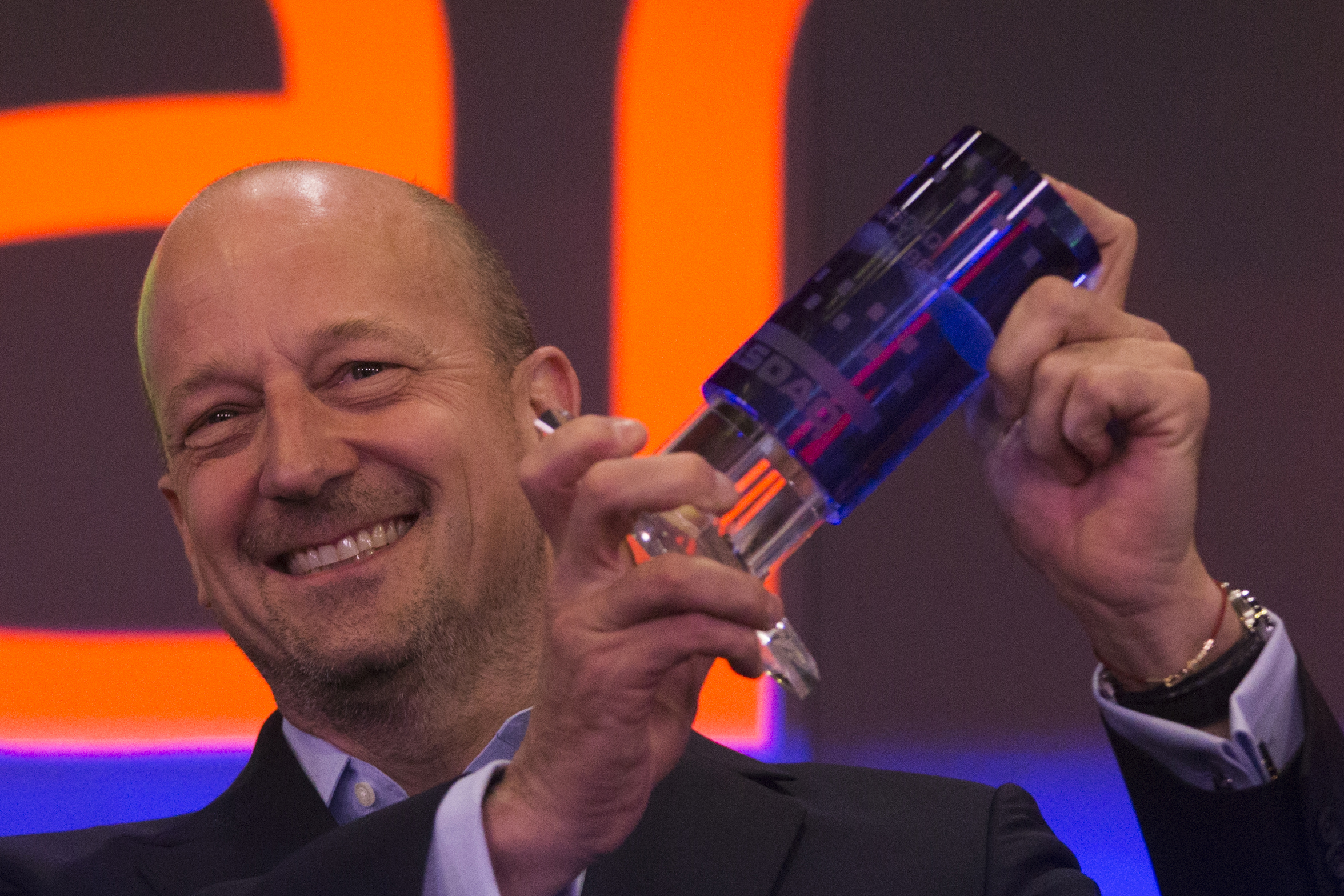 Markit CEO Uggla holds the Nasdaq opening bell crystal before his company's market debut at the Nasdaq stock market in New York