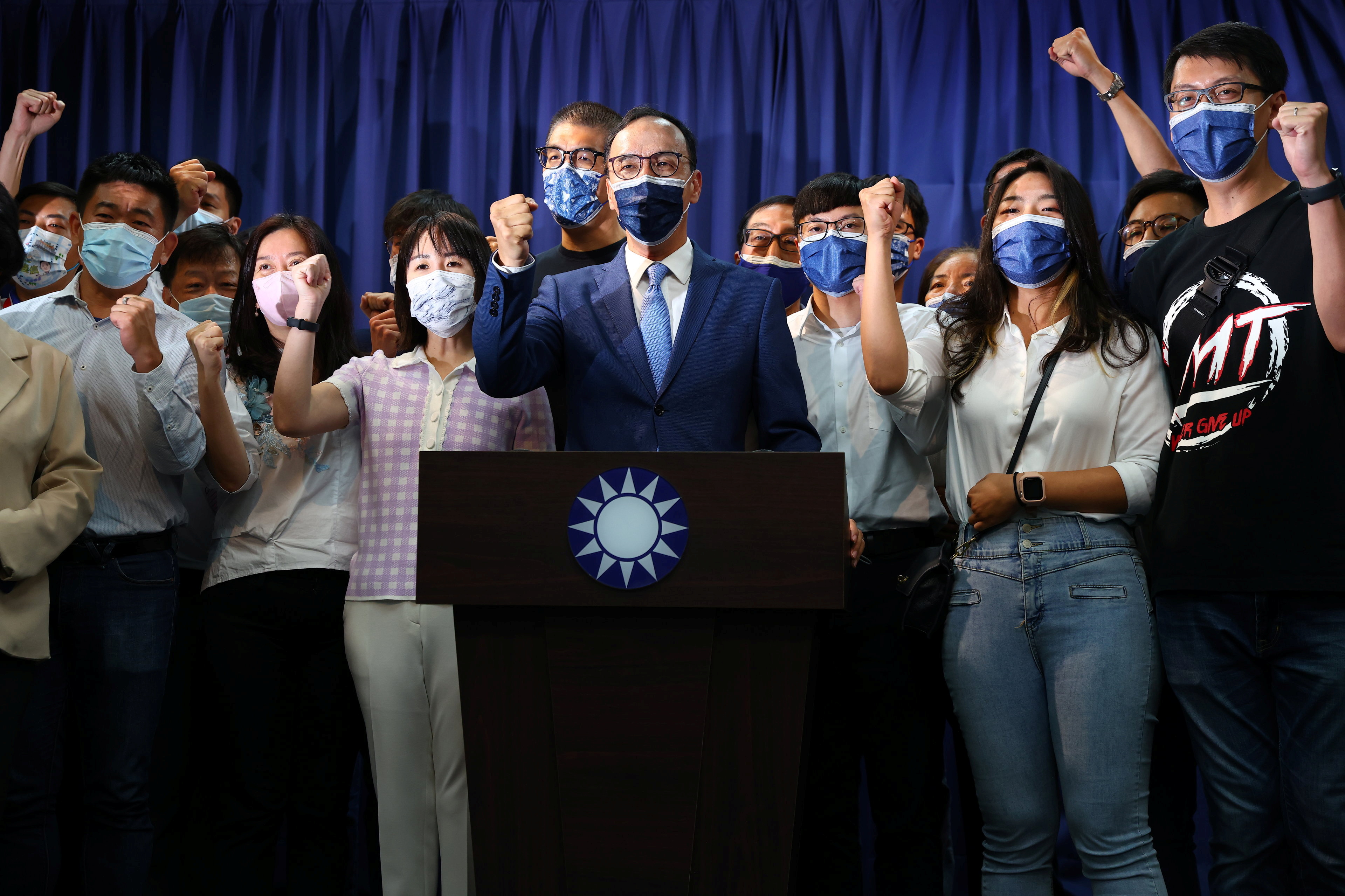 Eric Chu poses for a group photo after winning chairmanship of Taiwan's main opposition KMT party, in Taipei