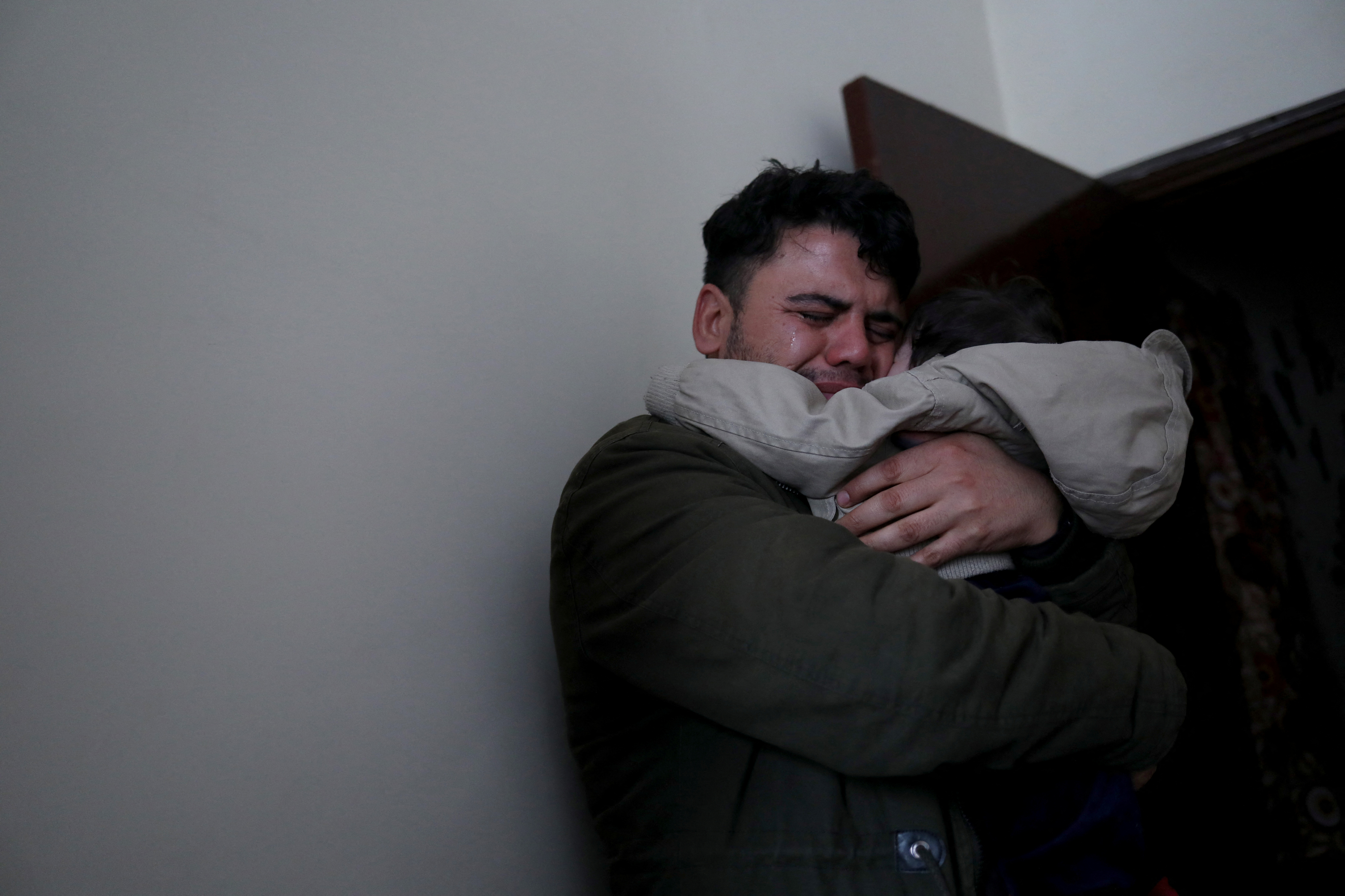 Hamid Safi cries as he hugs baby Sohail Ahmadi in Kabul
