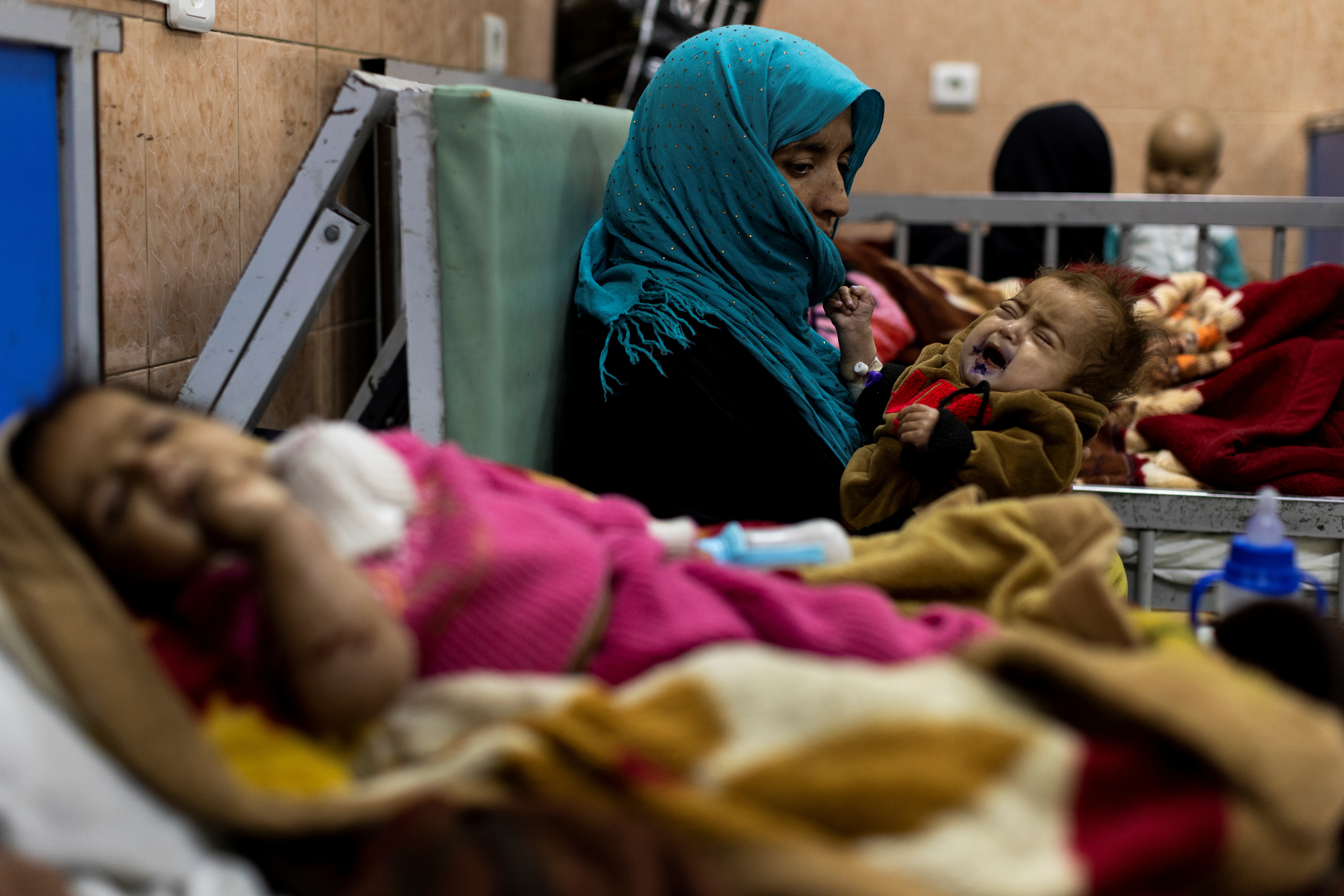 Farzana, 30, holds her one-year-old baby, Omar, at the malnutrition ward for infants of Indira Gandhi Children's hospital in Kabul, Afghanistan October 23, 2021. REUTERS/Jorge Silva