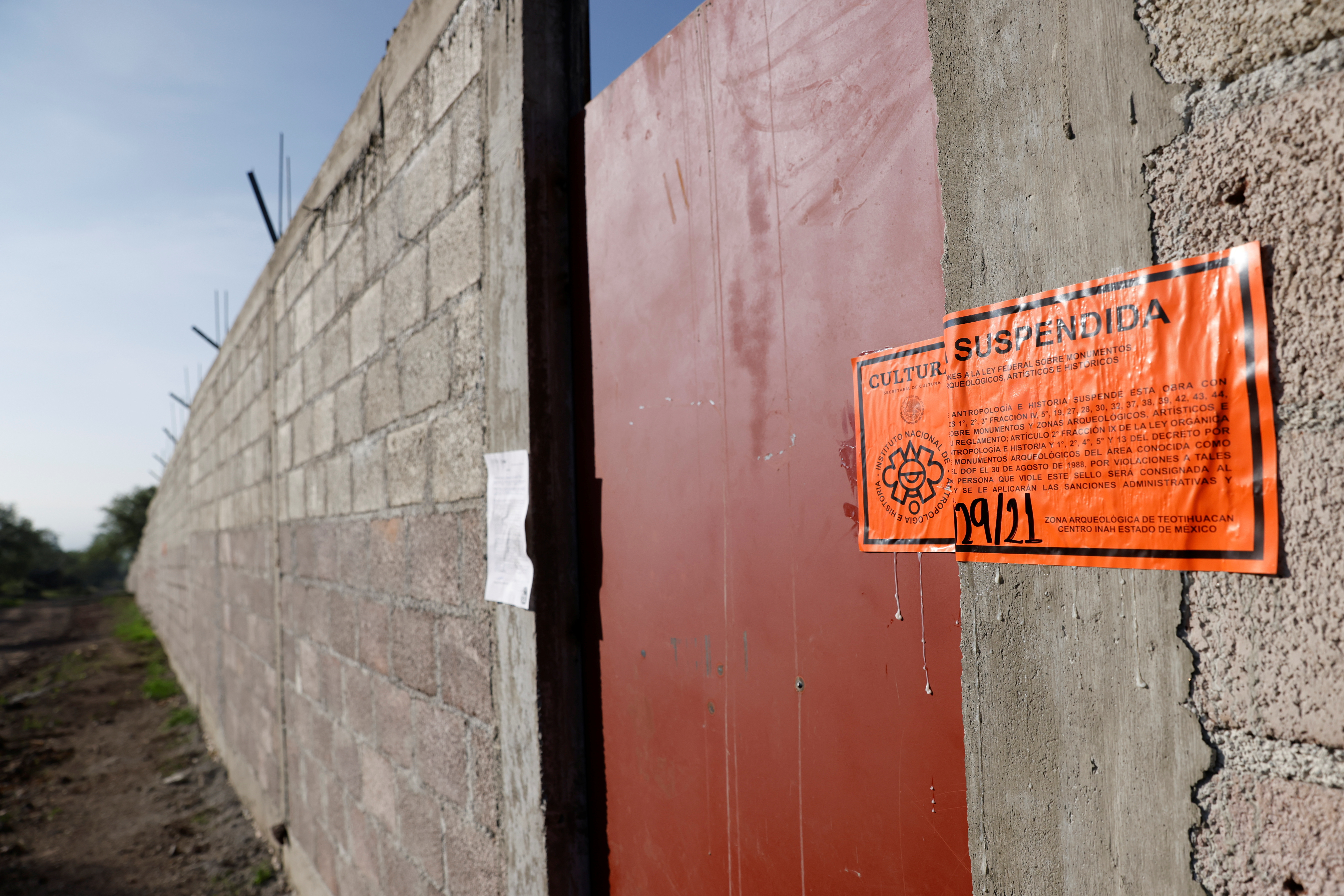 A stamp indicating the suspension of illegal construction is seen on the wall near the pre-Hispanic ruins of Teotihuacan in Oztoyahualco
