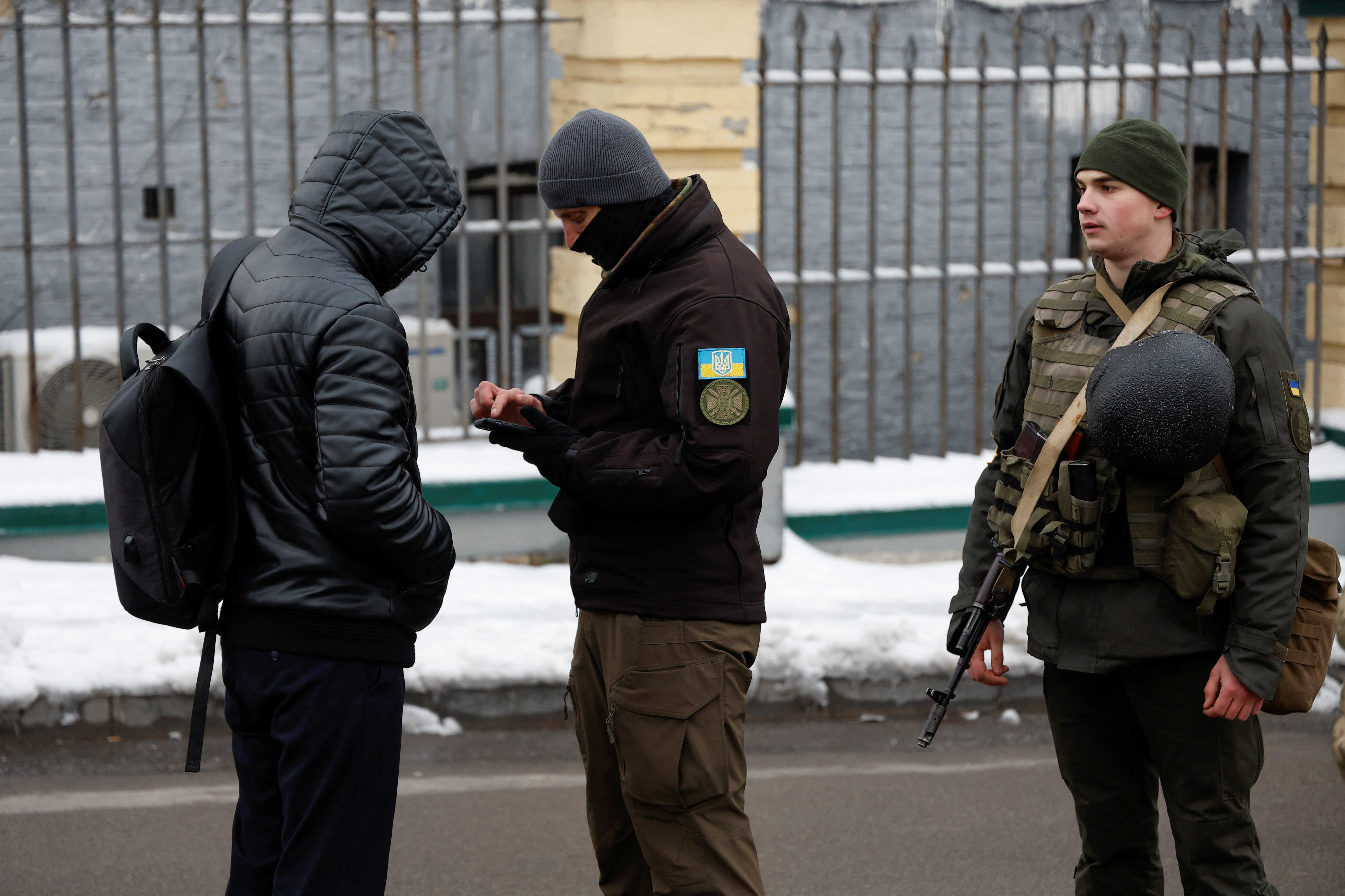 Ukrainian law enforcement officers check documents of a visitor of the Kyiv Pechersk Lavra monastery in Kyiv