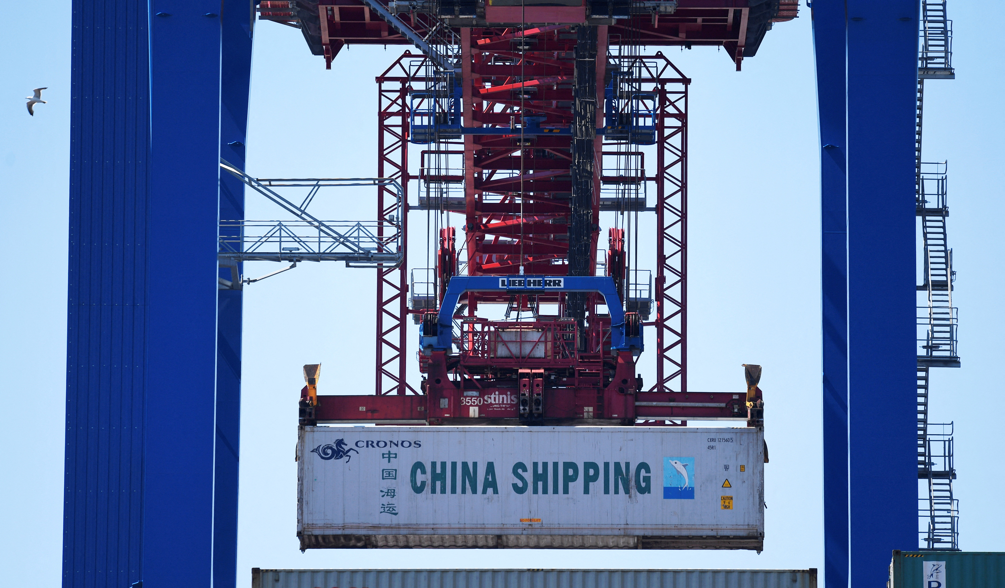 A container of China Shipping is loaded at a loading terminal in the port of Hamburg